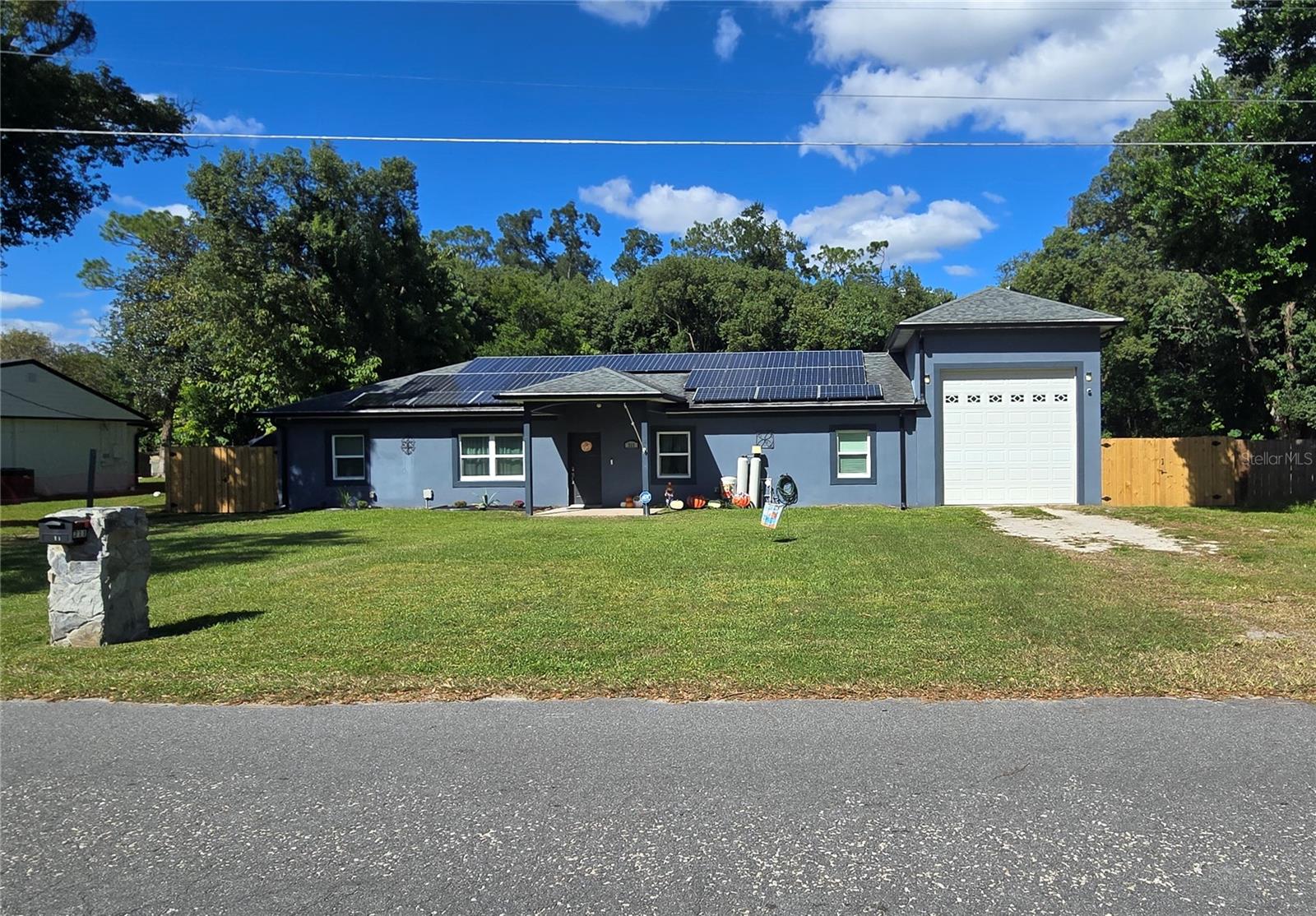 +++ HERE IS A UNIQUE OPPORTUNITY TO HAVE A 3 BED 2 BATH UPDATED HOME WITH AN RV GARAGE, AND A SEPARATE 1 BEDROOM 1 BATHROOM APARTMENT ON A .35 ACRE LOT WITH NO HOA +++  This beautiful property has been given many updates and upgrades in the last few years!  In the main house the kitchen has been completely updated from top to bottom! Both bathrooms updated, new storm rated windows, new front and rear doors, 2 solar tubes, light fixtures updated, flooring in 2 bedrooms updated. Owners also updated the electrical panel, water heaters in main house and apartment, added a water filtration system, solar panels for electricity that services both the main house and apartment. Gutters were also added along with new insulation in the attic.  The RV garage features 15 FT. doors on the front and back.  If you have a teenager living at home or a family member that wants their own space the apartment is perfect! You can also rent out the apartment for monthly income!!!  This is a rare opportunity for the right buyer looking for this specific layout as they are few and far between!