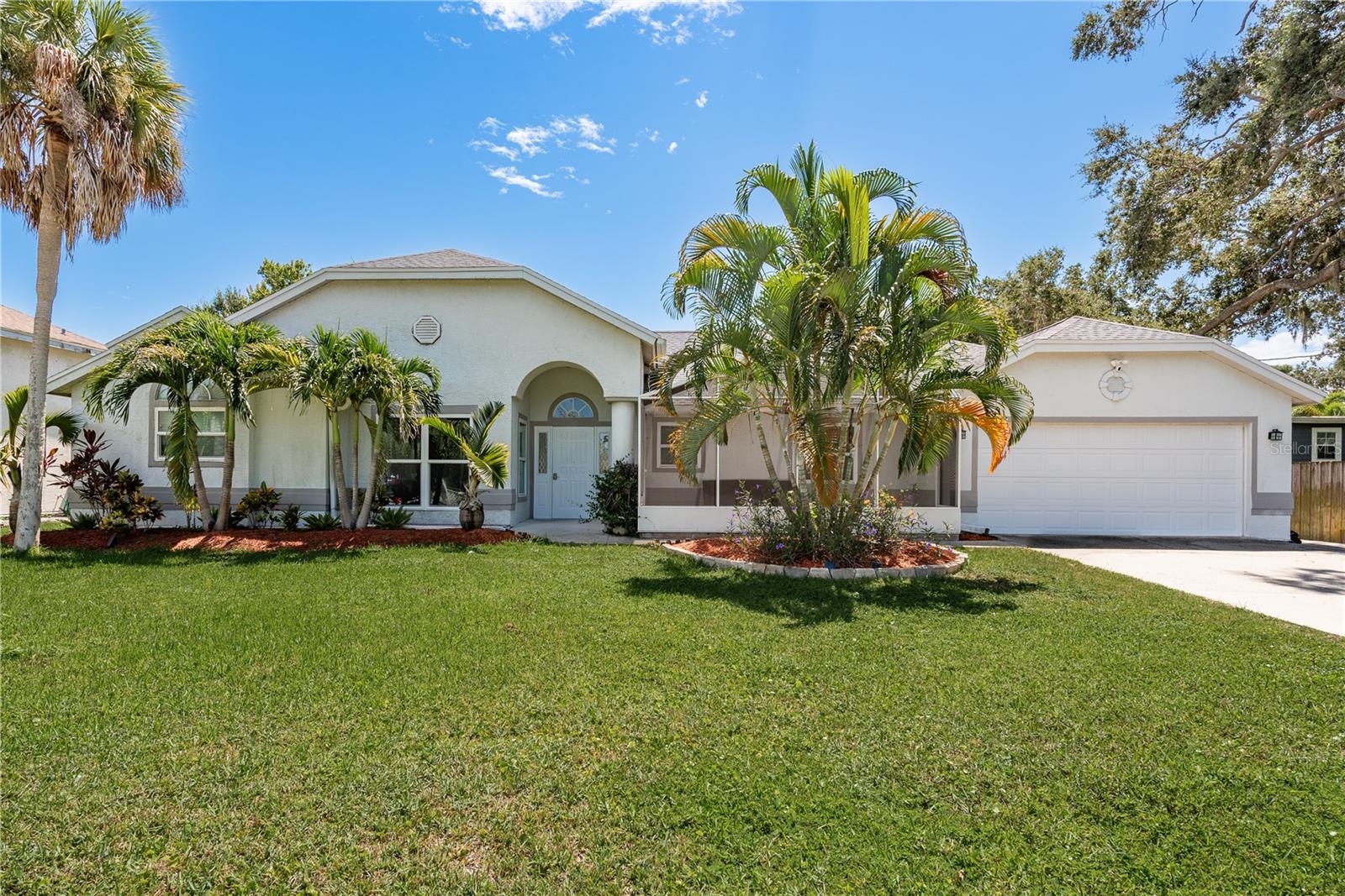 Step into modern comfort—this beautifully renovated home has every major upgrade already completed! This stunning 3-bedroom, 2-bathroom Palm Harbor home has been thoughtfully updated from top to bottom, with all the big-ticket items already taken care of—just move in and enjoy! A brand-new roof and AC system were both installed in 2023, along with a newer water heater (2022), offering long-term peace of mind. The freshly painted interior enhances the clean, modern aesthetic, complemented by stylish new ceramic tile flooring throughout (2024). The kitchen was fully remodeled in 2024 with luxurious Dolomite stone countertops, sleek cabinetry, and a modern design that flows seamlessly into the spacious living room with vaulted ceilings—the perfect setup for entertaining family and friends. The spa-inspired primary bathroom is a true retreat, featuring elegant marble countertops, a separate deep soaking tub, and a beautifully tiled walk-in shower that creates a relaxing, high-end feel. The primary suite also offers dual vanities and his-and-hers closets for added comfort and functionality. A separate flex space makes a perfect home office, creative studio, or reading nook, while the climate-controlled enclosed back room offers endless versatility for lounging, entertaining, or play. A fully fenced backyard provides privacy and space for outdoor enjoyment, while a charming screened front lanai offers the perfect spot to relax and unwind on Florida evenings. A rear door in the garage opens to a covered carport—ideal for extra parking, backyard access, or storing a boat or trailer. Located near top-rated schools, parks, shopping, and the Gulf beaches, this beautifully finished home is a rare opportunity in one of Palm Harbor’s most sought-after neighborhoods. Lake Shore Estates offers a voluntary community association, which includes access to a community clubhouse and private boat ramp with direct access to Lake Tarpon, a 2,500-acre lake perfect for boating and fishing. The current owners have an assumable flood insurance policy and reported no damage from either of the 2024 storms, providing added security and peace of mind.