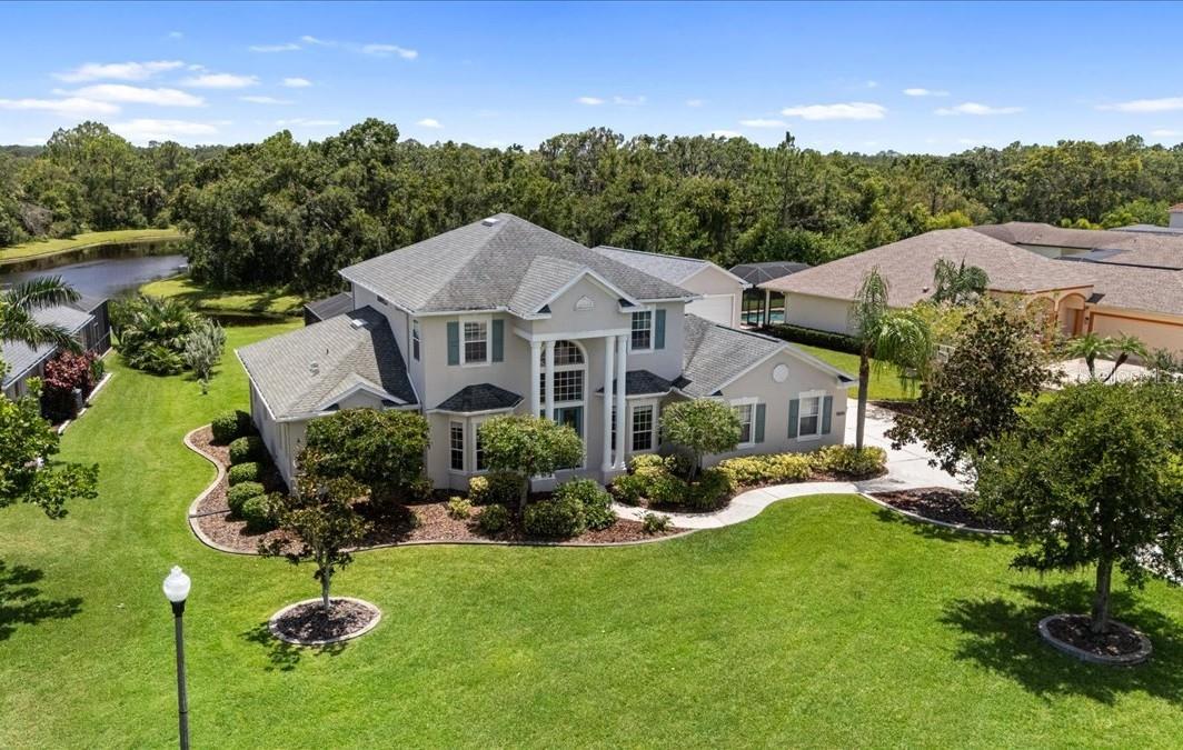One or more photo(s) has been virtually staged. Old Florida Charm Meets Modern Comfort! Welcome to this thoughtfully designed Valentine model by Lexington Homes in the heart of Twin Rivers, Parrish, FL. (No CDD and Low HOA fees) This spacious 4-bedroom, 3-bathroom two-story pool home with (RV/Boat Garage) offers nearly 3,000 sq. ft. of thoughtfully designed living space, complete with a dedicated den, formal dining room, and a flexible split-bedroom layout. The primary suite is conveniently located on the ground floor, complete with double vanity and soaking tub, while a large bonus room upstairs offers additional space for a game room, gym, or media room. The inviting open-concept kitchen and living area is perfect for entertaining, with solid surface countertops, rich wood cabinetry, and stainless-steel appliances. Relax poolside with picturesque views of your private Zero-Entry custom pool with sundeck and the peaceful pond, perfect for quiet mornings or evening sunsets. This home also features a detached garage (W-15' x L-45', H-14.5') with electric, providing endless possibilities including a separate finished office space attached to the detached garage. The garage is ideal for motorhome, boat storage, workshop, or a hobby room. Key upgrades include ROOF replaced in (2018) Both A/C units replaced in (2018), Tank-less water heater replaced in (2018), and a (Whole-House Generator on propane) for peace of mind. The RV/Boat garage was built in (2021). Twin Rivers is a nature lover's paradise offering 1,800 acres of peaceful bliss! Private river access and private boat ramp for kayaking, canoeing, and fishing, a boardwalk, miles scenic hiking trails, playgrounds, basketball court, soccer field, beach volleyball, and a picnic pavilion. Hundreds of acres of preserved green space ensure a peaceful, wildlife-rich environment. Whether you're looking to relax in your backyard oasis or explore the vibrant outdoor amenities, this home truly delivers the best of Florida living. Zoned for some of Parrish's top-rated schools, including Annie Lucy Williams Elementary, Buffalo Creek Middle, and the highly acclaimed Parrish Community High School, a newer "A-rated" campus just minutes away. Families will appreciate the convenience of shopping, restaurants, and quality of education offered within close proximity to Twin Rivers. Schedule your private tour today and discover why Twin Rivers is one of Parrish's most sought-after communities.