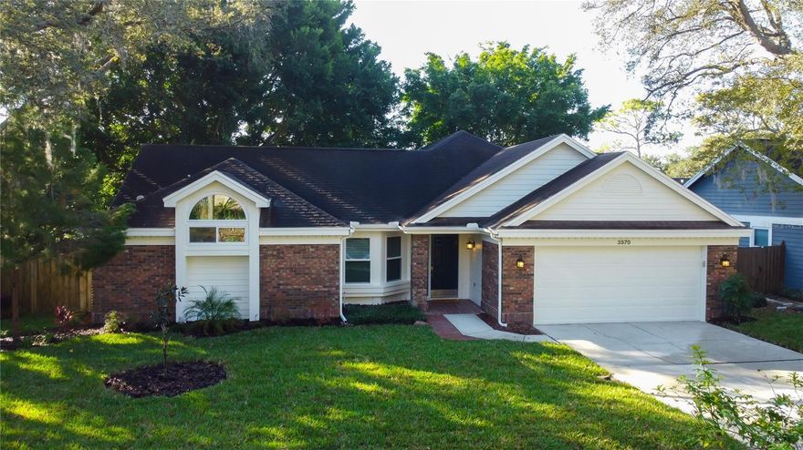 CLICK 3D TOUR LINK for IMMERSIVE VIRTUAL TOUR! 1-Story 3BD/2BA/2CG Home w/Privacy by Design Split-Bedrm Floor Plan, 10’ Vaulted Ceilings Throughout—including Main Bedrm—Creates a Bright, Spacious Aesthetic. EXCEPTIONAL Location in Highly Sought Out “Village of Woodland Hills” Known for A+ School Districts, Flood Zone X + Evacuation Zone D, Quiet, Established Neighborhood w/ Friendly Neighbors; Best of All, Community Amenities for $253 Bi-Annually Include Pool, Playground, Tennis/Pickleball Courts, all w/o Responsibility of Private Ownership or Maintenance. Versatile Layout Offers 2 Sizeable Great Rooms: 1st Combines Dining/Living Areas; 2nd Combines Kitchen/Family Room Areas. Eat-In Kitchen Space is Enveloped by Bay Windows. Ample Size Dining Area in Front Great Room or if You Host Large Dinner Parties, Use Family Room as a Dedicated Dining Room. There’s Excellent Flexibility for Entertaining, Working from Home, or Multi-Purpose Living. Consistent Laminate Flooring Creates Visual Cohesion; Waterproof Tile in Foyer/Baths Adds Durability Where it Matters Most. Enjoy a Freshly Painted Neutral Interior/Exterior Color Theme, as it Allows You to Personalize the Space w/Décor & Furnishings. Kitchen Offers Solid Wood Cabinetry Painted w/a Refreshing Coastal Blue, Creating a Relaxed, Modern Aesthetic that Blends Well w/Mosaic Backsplash, Newer Stainless-Steel Appliances, (Including Double Oven), & Stone Countertops. Cabinetry Includes a Thoughtful Mix of 48”/ 42” Upper Cabinets, Select Glass-Paneled Doors, Top Molding, Under-Cabinet Lighting. Large Closet-Pantry Provides Xtra Storage. Wide Elongated Peninsula Easily Sits 3, Houses a Farmhouse Sink, & Faces Family Room- Allowing Whoever’s on Clean-Up Duty to be in the Conversation. Primary Suite Features an Open Area Dual-Sink Vanity, Framed by an Arched Entry, Further Complemented w/Arched Transom Windows to Bring Soft Natural Light Inside (Home Faces NW). A Tastefully Tiled, Sunken Shower & Toilet are Privately Enclosed, Permitting Shared Use of the Bathroom in a Comfortable, Functional Way. Oversized Walk-In Closet w/ Double Hung Racks for Maximum Storage + Room to Add Shelving! 2nd Bathroom is Flanked by Bedrm #2 & #3, has a Single Vanity & Tub/Shower Combo. Both Baths Were Regrouted & Look Fresh/New!! Bedrooms #2/#3 Windows are Fitted w/Blackout Cellular Shades, while all 3 Oversized Sliding Glass Doors to Lanai have Modern Wide-Paneled Vertical Blinds. Ceiling Fans w/ Lights in Living/Family Rooms, Kitchen, + All Bedrooms (Most w/Remotes). Pass-Through Laundry Room from Garage has Cabinetry (Washer & Dryer Incl). *IMPROVEMENTS* ROOF 2014; HVAC System 2018; Impact Glass Windows Throughout 2019 (Except 3 Sliding Glass Doors & they have Hurricane Shutters); Rheem Water Heater 2025. Birdcage Lanai Rescreened 2018; Salt-System Water Softener 2018; Updated all ‘Needed’ Fascia Boards & Wood Siding w Hardiplank 2025; Fresh Interior/Exterior Paint; Front Yard Sodded w/St Augustine; Orbit Sprinkler System (Front Yard) Maintenanced & Backflow Preventer Installed. Fully Fenced Private Backyard Features Mature Banyan Trees Framing the Yard on Each Corner – Unique to Residential Settings – w Shade Trees Lining Perimeter! Outdoor Living is a Reality w/a HUGE Enclosed Lanai, Partially Covered by ‘Main Roof’ (*NO Flat Roof!). Located in one of N. Pinellas County’s Most Popular & Welcoming Neighborhoods, This Home Delivers Comfort, Versatility, & Long-Term Value w/Valued Amenities That Are Rare to Find!