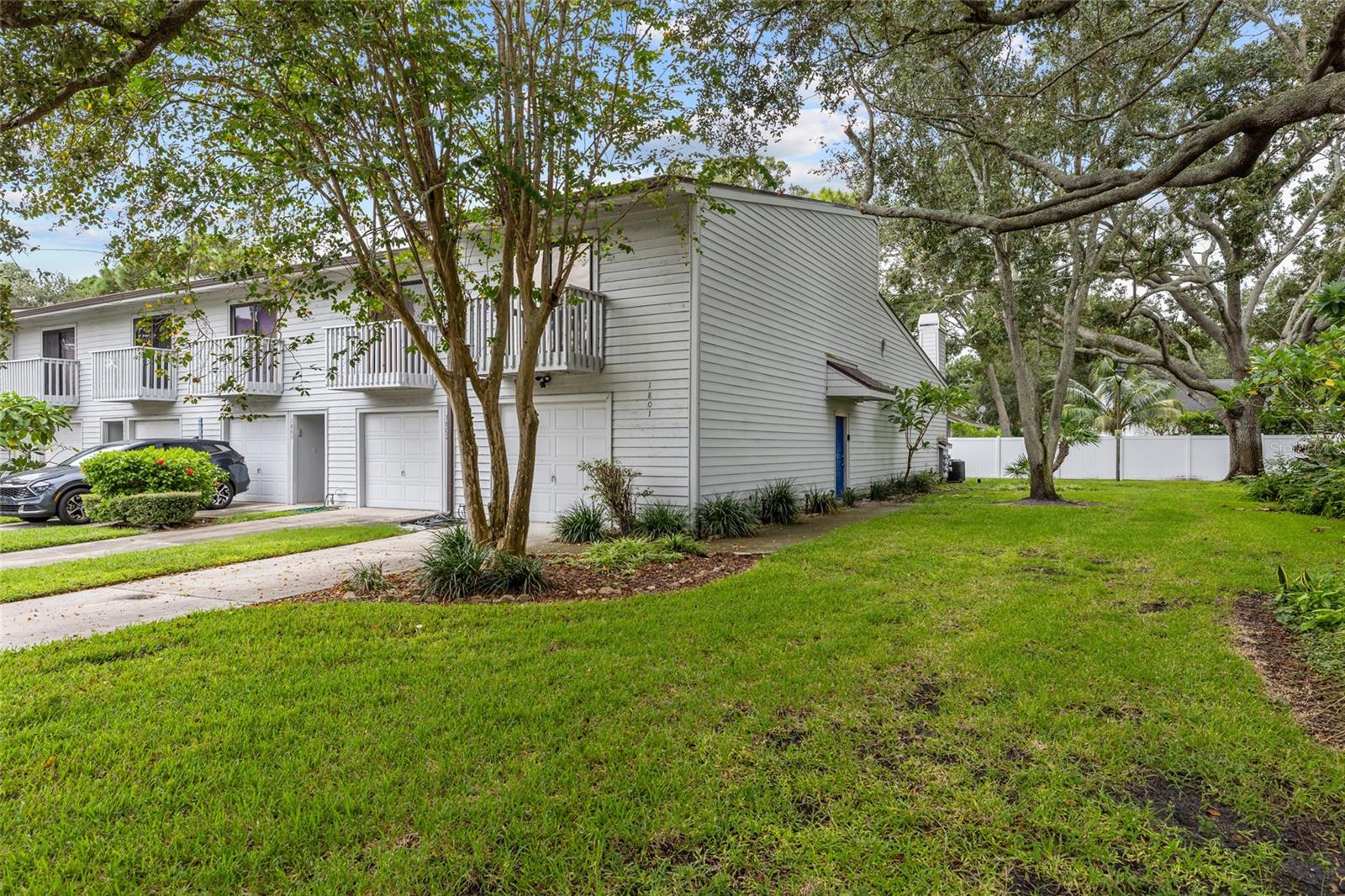 One or more photo(s) has been virtually staged. Welcome to this beautifully maintained 2-bedroom, 2-bathroom end-unit townhouse offering maintenance-free living—and it's not located in a flood zone! This spacious tri-level home features an oversized 1-car garage with abundant storage and a driveway that accommodates multiple vehicles. On the first level, you’ll find a versatile bonus room—perfect for a home office or workout space—along with a washer and dryer and additional storage. The second floor boasts stylish, vinyl plank flooring throughout. The kitchen is equipped with a newer range and refrigerator, butcher block countertops, and a breakfast bar that opens into the dining area. The sunken living room features vaulted ceilings with skylights that fill the space with natural light, a wood-burning fireplace, and access to a screened porch via stacking sliding doors—ideal for relaxing outdoors. Both bedrooms and bathrooms are located on the third floor. The primary suite includes built-in shelving in the closet, a private balcony and an ensuite bathroom with a new sink and vanity. The HOA fee of $648 a month covers the heated pool, exterior maintenance, reserves fund, roof, grounds maintenance, sewer, water, trash, cable, internet, and private road—truly low-maintenance living! Work has begun on putting new, exterior siding on the buildings. The community is directly across the street from Forbes Recreation Center and Helen Howarth Community Park, featuring a dog park, playgrounds, picnic pavilions, ball fields, and walking/horse trails. It’s also conveniently located near I-275, restaurants & shopping; two international airports; award-winning Gulf beaches; and the vibrant downtowns of St. Petersburg & Tampa. Don’t miss your chance to own this turnkey townhouse in a prime location with everything you need right at your doorstep!