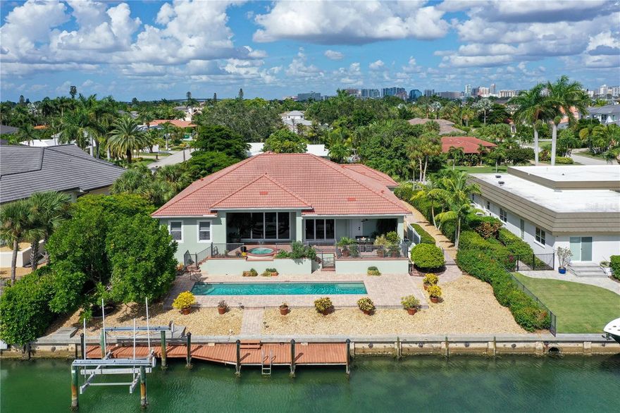Southern Exposure on Sailboat Waterfront on Desirable Bird Key: Perfect for boating enthusiasts, this home showcases indoor/outdoor living and epitomizes coastal elegance with serene Sarasota Bay views. Nestled on a prime deep-waterfront site, it offers stunning bay and canal views, a private boat dock with lift, and quick bay access. Built to hurricane standards (elevated to 11’ 2” with impact windows and sliding glass doors), this eco-friendly home boasts 12’ high ceilings, crown moldings, retractable glass doors, a gourmet kitchen with an induction cooktop (convertible back to gas), and a secluded master suite with bay views, dual walk-in closets, an opulent bathroom, and a sunlit office. Unwind in the bay-view spa or entertain effortlessly, indoors or poolside. Located a short distance from downtown Sarasota, St. Armands Circle, and pristine beaches. Bird Key is one of Sarasota’s premier waterfront communities, near Lido Beach, Longboat Key, and Siesta Keys. Within walking or biking distance to Bird Key Yacht Club, which offers exclusive amenities, including a fitness center, tennis courts, or additional boat dockage (fees apply). Experience this splendid home’s idyllic setting, newer updates, and proximity to amenities for a truly desirable coastal lifestyle to create everlasting memories. Copy this link for Matterport Website - https://my.matterport.com/show/?m=8TLCqSmavJu
