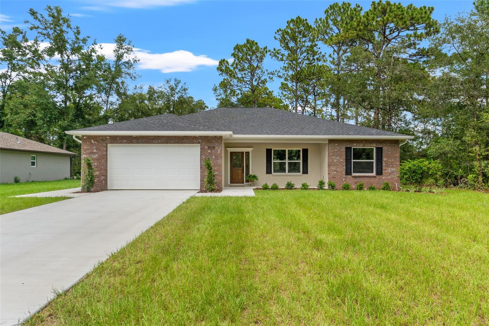 Discover the difference in this exceptional new construction home—crafted with attention to detail and quality that far surpasses typical builder grade finishes. From the moment you arrive, you’ll notice the upgrades that set this home apart, including full home gutters, a complete irrigation system, and inviting front and rear porches finished with insulated tongue and groove ceilings for timeless charm and comfort.
Step inside to find 10-foot ceilings in the main living area, accented by crown molding and illuminated tray ceilings.The kitchen is a true centerpiece with quartz countertops, custom soft close solid wood cabinetry, a brick backsplash, pot filler, porcelain apron sink and under cabinet lighting. The spacious 3-bedroom, 2-bath layout features a desirable split floor plan, offering both functionality and privacy. Enjoy energy- efficient and sound-dampening insulated interior walls, while oversized handicap-accessible door openings throughout the home offer enhanced mobility and comfort. Beautifully wood-cased windows add warmth and architectural detail. The Laundry room is equipped with cabinets, a utility sink and additional storage space. The oversized garage and impact-rated garage door offers space and extra protection.The kitchen and living areas are designed for both daily living and entertaining, while the lot provides plenty of space for a future pool.This isn’t just another house—it’s a custom home built with integrity, style, and comfort in mind. This home redfines new construction- offering craftsmanship and comfort that stand out from the rest. Don’t miss your chance to own a property where quality comes standard. Schedule your showing today!