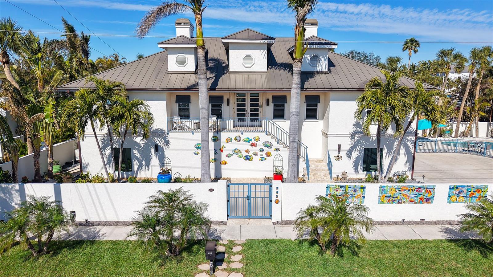 Discover the pinnacle of luxury living on St. Armands Circle, Sarasota's most sought-after destination, where every detail embodies the vibrant coastal lifestyle. This stunning 4-bedroom, 3.5-bathroom home spans over 4,600 square feet of beautifully finished living space, including a fully renovated first floor that features extra-large porcelain floor tiles, Family Room, Guest Rooms and beautifully updated guest bathroom with floating vanity and luxurious shower with floor to ceiling tile. Just moments from Lido Beach and steps from the iconic St. Armands Circle, this turnkey, fully furnished home offers an extraordinary living experience.
Meticulously updated over the past two years, no detail has been overlooked. The chef's kitchen boasts premium Wolf, Subzero, and Bosch appliances, paired with sleek new quartz countertops and impeccable craftsmanship. Throughout the home, you'll find elegant wood and marble flooring, completely remodeled bathrooms, and upgraded lighting and ceiling fans all designed to create a contemporary, luxurious atmosphere.
The home’s updates extend to the roof, featuring skylights for enhanced natural light, while hurricane impact windows and doors ensure both safety and tranquility. Enjoy year-round comfort with updated A/C systems at both levels. Take in the beauty of the fully renovated pool area with new travertine decking, fully refreshed lush landscaping, and modern fencing. The exterior is equally impressive, with new copper gutters, a striking front door, and a custom privacy wall featuring bespoke ceramic art by a renowned Florida artist.
With state-of-the-art security features—including a surveillance system, alarm system, and new gate openers—this home offers complete peace of mind. This isn’t just a house; it’s a lifestyle, offering unparalleled access to all the Sarasota amenities and putting you just steps away from the beach, shopping and dining. Welcome to the ultimate Florida living experience at 345 Madison Drive.
Seller Financing May Be Considered.