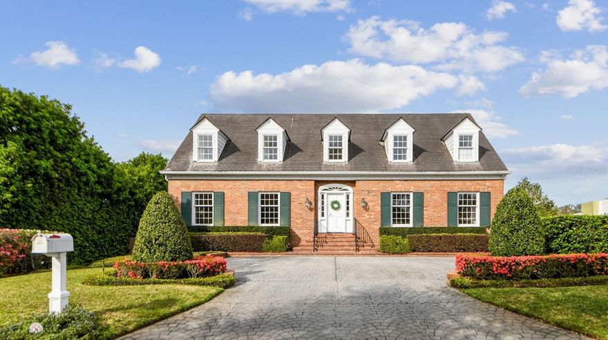 Traditional Winter Park LAKEFRONT estate on the shores of Lake Virginia with stunning unobstructed views that overlook the Genius Drive nature preserve. This beautiful four bedroom, four bath, three level home is a rare find on the Winter Park Chain of Lakes. The main level, with hardwood floors throughout, offers speculator views of the lake from the moment you walk in the front door.  Spacious separate dining and living rooms, family room, with french doors that open to the oversized balcony where you will have gorgeous panoramic views of Rollins College and the Winter Park skyline, two fireplaces, one wood-burning and one gas, a large office overlooking the lake, a guest bath, and a large kitchen with tray ceilings, a butcher block island, two pantries and a large dining area with french doors that open to the balcony. There is a green house with a watering system that is accessible from the kitchen and the balcony.  The master suite on the second level offers spectacular views of the lake and two large custom walk-in closets. Three additional bedrooms and a guest bathroom complete the second level. There is a full stand up attic with a stairway in one of the bedrooms. The lower level offers a 33 x 18 game room with a wet bar and opens to the 20 x 40 newly refinished pool, a separate pool bath, laundry room, workshop and entry into the three car garage.  The beautiful lushly landscaped backyard leads the way to a private boathouse and custom dock with over 100’ of lake frontage.  This is an incredible opportunity to live in the existing home, remodel or build your own on the Winter Park Chain of Lakes.