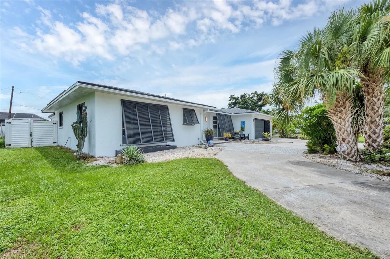 This home is truly special! Welcome to this beautifully updated 2-bedroom, 2-bath pool home featuring a one-of-a-kind pool cabana—perfect as a home office, art studio, or flex space. Inside you’ll find a wide-open great room floor plan with built-in cabinetry, new flooring, and a chic, neutral palette. The kitchen and both baths were remodeled and provide modern finishes and a fresh, stylish look, including custom closet systems for organized storage. The backyard is designed for entertaining with an oversized lanai space featuring a large free form pool that was resurfaced/re-tiled in 2022, complete with a new electric heat pump and pool pump. The pool cabana, added in 2022 and equipped with its own mini-split A/C, creates the perfect space for work or play. From the main home, view and access the dramatic outdoor shower space surrounded by custom tropical artwork with elevated hardware for the ultimate outdoor shower experience. The property is fully fenced for privacy and includes an oversized garage for all your extras. This home has been thoughtfully updated with a newer roof (2021), new ductwork (2021), updated plumbing with a Manabloc system, new water heater, and solar panels powering the entire house added in 2021 to keep those electrical bills low. Additional improvements include a new A/C system 2022, updated electrical with an outlet for a generator, remodeled kitchen and baths, radiant barrier was added to the attic, and some impact windows were added for peace of mind. Located in Venice East, a community with a voluntary HOA and no deed restrictions, you’ll have the freedom to bring your boat, RV, and the extras. All of this is just minutes from Wellen Park, downtown Venice, Gulf beaches, dining, and shopping. This jewel won’t last long—schedule your showing today!