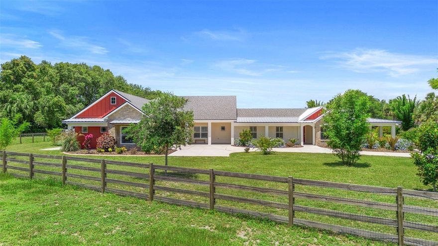 Discover the perfect blend of the ideal living space, privacy, and convenience with this stunning ranch-style home situated on 7.91 high-and-dry acres. Located on a paved road with no HOA, this fully fenced property is ideal for horses, cattle, or recreational toys! With 3313 sq. ft. of total living space, this Split Plan Plus home features two full living areas, each equipped with its own kitchen and laundry rooms, including appliances. This Split Plan Plus layout makes it an excellent choice for multigenerational living or a private retreat for extended family. There is an office space that can easily be converted into a fourth bedroom, an interior mud room-dog grooming station with a vanity and shower inside the grooming station.  A breezy wraparound porch that provides easy access to all entrances and offers a welcoming outdoor living space. Step outside to enjoy professionally landscaped gardens designed for both privacy and beauty. The property also boasts a massive 36’ x 108’ barn, complete with concrete breezeways (both center and side), two 12’ x 24’ enclosed rooms (one with an additional exterior 12’ x 24’ concrete pad). The barn roof was installed in 2019. This prime location is just 13 minutes away from two Publix grocery stores and less than 20 minutes from Sanford, Oviedo, Mims, I-95, and the 417 toll road. Additionally, an 86-inch TV with a new console will convey with the home. Notable updates include: - New roof completed in fall 2023 for the entire house - A 1990 sq. ft. addition completed in late 2023 - A 1323 sq. ft. area completely remodeled - Granite countertops throughout - Waterproof luxury vinyl and tile flooring - Whole-house water processor 10/2024 - Oversized 2-car garage with a rear bay door and access door - An office/flex room that can be converted into a fourth bedroom - A large storage room under A/C and a storage room above the garage (28’ x 8’ x 6.15’) - A dog grooming room/mud room with a shower and sink, an outside kennel, and a doggy door. The entire house is connected to a new septic system (completed in late 2023) This unique property combines modern updates with rural charm and is ready for your family, pets, and lifestyle!