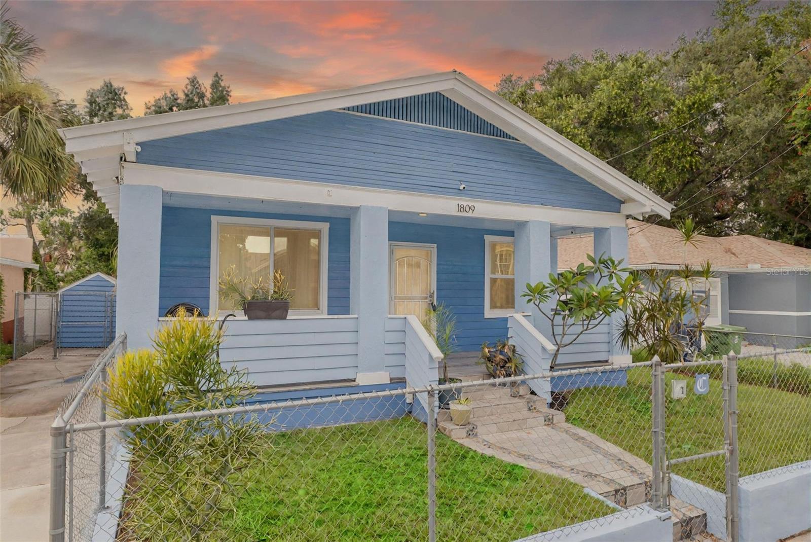 Charming, Solar Powered Home Near Historic Ybor City – No Flood Zone & Fully Furnished Option. 1809 E 23rd Avenue, Tampa, FL 33605. Discover comfort, efficiency, and convenience in this beautifully maintained 3 bedroom, 2 bathroom home featuring a durable metal roof and fully owned solar panels, located just minutes from the heart of Tampa’s Ybor City Historic District. Situated in a non flood zone (Flood Zone X), this home delivers lasting value with transferable warranties on new windows and mini-split A/C units throughout. Step inside to enjoy high ceilings and a bright, open-concept living space with tile flooring in all common areas and cozy carpet in the bedrooms. The indoor laundry and utility room features a whole-home water filtration system, adding comfort and convenience to everyday living. The kitchen, dining, and living areas flow seamlessly, ideal for entertaining or relaxing at home. Plus, with the option to purchase fully furnished, this home is truly move-in ready for a variety of buyers, whether you’re looking for a primary residence, second home, or investment property. Outside, you’ll find a fenced-in yard, private driveway, storage shed, and a large covered front porch that enhances curb appeal. The neighborhood is well-lit with newly updated street lights, providing a warm and welcoming atmosphere. This property also may qualify for select loan programs and buyer assistance options, offering potential financial flexibility for eligible buyers. Consult with your lender to explore what opportunities may be available to you. Enjoy excellent connectivity just minutes from the I-275 and I-4 junction, offering direct access to all of Tampa Bay including Downtown, the beaches, Brandon, Lakeland, and even Orlando. Live near the cultural richness of Ybor City, known for its unique shops, Cuban cuisine, and vibrant nightlife, while being only a short drive from Downtown Tampa destinations like Curtis Hixon Park, the Tampa Riverwalk, Florida Aquarium, Amalie Arena, and Armature Works. Further south, enjoy boutique shopping in Hyde Park Village or a scenic stroll along Bayshore Boulevard, the longest continuous sidewalk in the world. For those in academia, this location offers outstanding proximity to several local colleges. The University of Tampa is just 1.5 miles away, Florida College is 2.5 miles away, and Hillsborough Community College is only 3 miles from your doorstep. This home offers the perfect balance of style, energy efficiency, and location, a rare opportunity in today’s market. Schedule your private showing today and don’t forget to ask about the fully furnished option and qualifying loan programs!