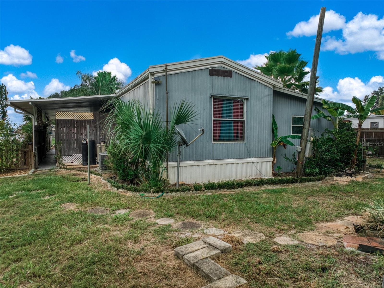 Welcome to this inviting 2-bedroom, 2-bath mobile home on a spacious quarter-acre lot! Inside, the open floor plan flows
easily from the living area to the eat-in kitchen, which features a convenient breakfast bar for casual meals. Two good
sized bedrooms with full bath. A dedicated laundry hook-up area adds to the home’s functionality, and the large enclosed
patio extends your living space—ideal for relaxing, entertaining, or enjoying the view of the fenced backyard. Outdoors,
you’ll find a versatile workshop/storage space, a shed, and plenty of parking, including a covered carport for convenience.
With room to spread out and practical features throughout, this home offers comfort, flexibility, and value—all on a
generous lot that’s ready to enjoy.