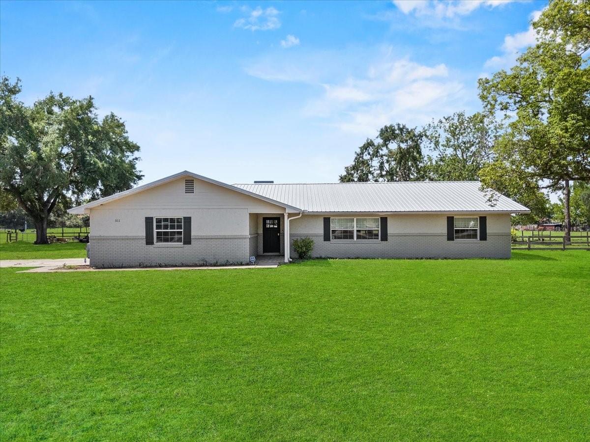***PRICED TO SELL AND BELOW APPRAISED VALUE***Experience the allure of country living in this beautiful three-bedroom, two-bath home offering over 2,000+ sf of comfortable living space. Nestled on 9.68 acres, this property features a charming two-stall red barn, perfect for your horses, cows, goats and chickens. As you step inside, you’ll be greeted by a cozy open floor plan that seamlessly connects to an incredible kitchen, boasting stainless steel appliances, custom cabinets, and elegant granite countertops. The expansive 4’ x 10’ island, equipped with a gas cooktop stove, makes this kitchen a chef's dream. It flows effortlessly into the formal living room featuring a welcoming wood-burning fireplace, perfect for cozy gatherings. Crown molding enhances the common areas, adding a touch of sophistication throughout. The master bedroom is a true retreat, featuring a spacious walk-in closet and an en-suite bathroom with a luxurious walk-in shower, complete with floor-to-ceiling tile, a glass enclosure and double vanities topped with granite. You'll appreciate the convenience of an oversized laundry room equipped with floor-to-ceiling cabinets and a granite countertop folding station. This home has been completely updated in 2018 to include modern upgrades, including a new metal roof (2018), a tankless gas water heater, updated plumbing (2018), a water filtration system, and a whole-house generator. Ground-mounted solar panels supply power to the entire property (2023), complemented by two large solar batteries and an EV charger for electric vehicles (2023), making this a virtually off-grid oasis with significant cost-saving features. Additional highlights include new windows and doors, porcelain tile floors throughout, an alarm system with cameras, and an oversized garage with a gun safe. The new AC system (2025) is DC inverter-driven, while a new well pump and pressure tank (2024) were installed in 2024, along with a new washer and dryer. To top it all off, enjoy the beautiful views of the sprawling property from the 12 x 40 screened porch that includes a new hot tub, inviting you to unwind and enjoy your serene surroundings. Embrace the tranquility and space that this rural retreat has to offer!