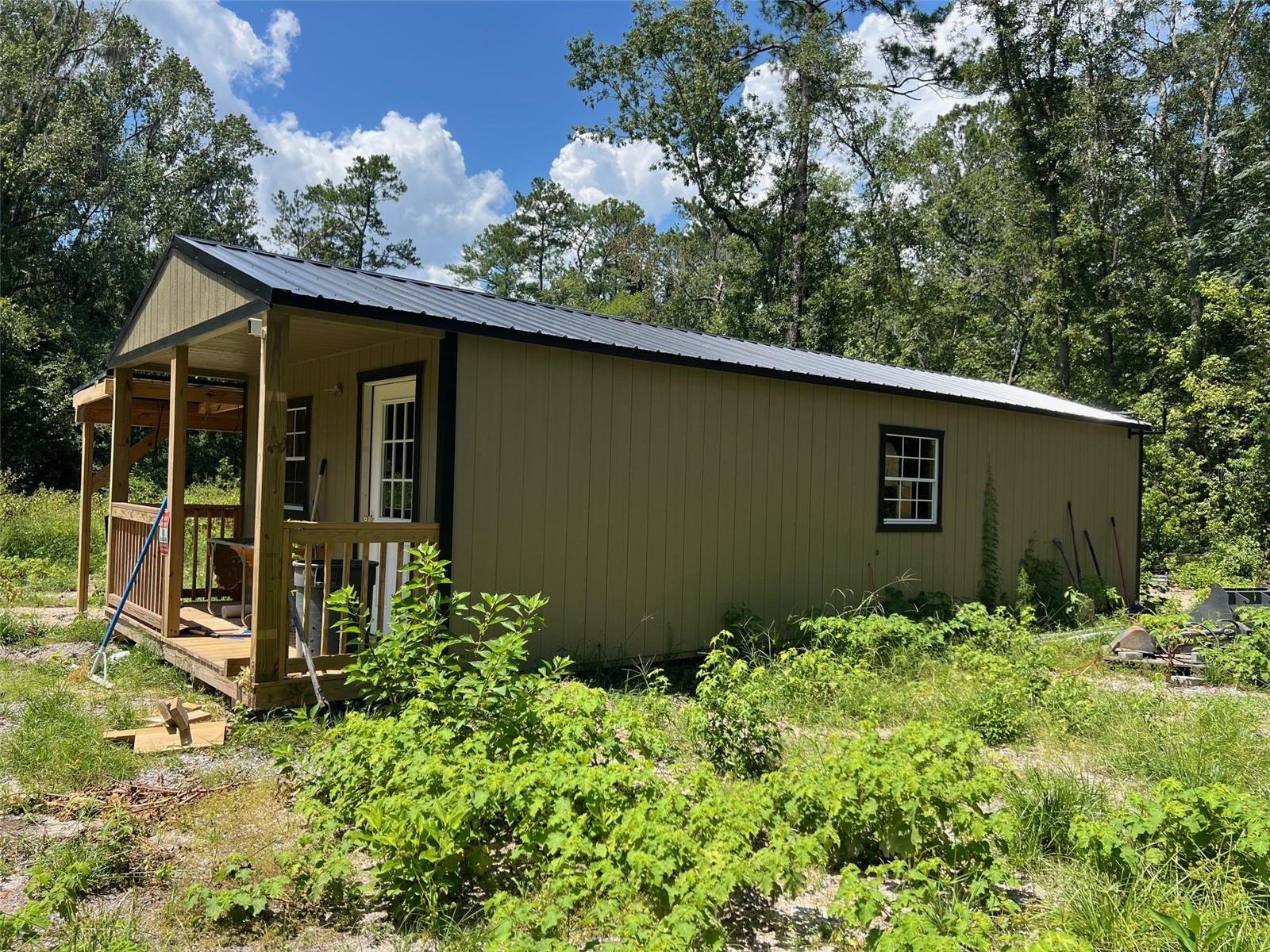 Tucked away in the peaceful woodlands of Northwest Gainesville, this rare 2.68-acre parcel offers privacy, readiness, and the head start you’ve been looking for. Thoughtfully improved and ready for your custom build, the property comes equipped with a brand new 14'x40' insulated building ready for power with an interior bathroom currently being finished. Whether you envision a workshop, guest space, or home office, this versatile structure is a valuable asset from day one.
The groundwork has already been done — literally. Two permitted septic systems are in place: one serving the building, and another ready for your future home. A recently installed well has already been trenched to the building, and a 20'x50' pad area has been prepped and ready for a garage, barn, or utility building. Adding to the value and convenience, the property is exempt from the new City of Gainesville sidewalk requirement — a significant savings on future construction.
Nature lovers will enjoy the regular sightings of deer and wildlife, while practical minds will appreciate that the property is high, dry, perk tested, surveyed, and has a GRU transformer already in place for easy electric hookup.
With no HOA, room to spread out, and a head start on utilities and infrastructure, this unique slice of land is a perfect blend of natural beauty and modern convenience. Build your dream home in a setting that feels miles away — yet is still close to all that Gainesville has to offer!