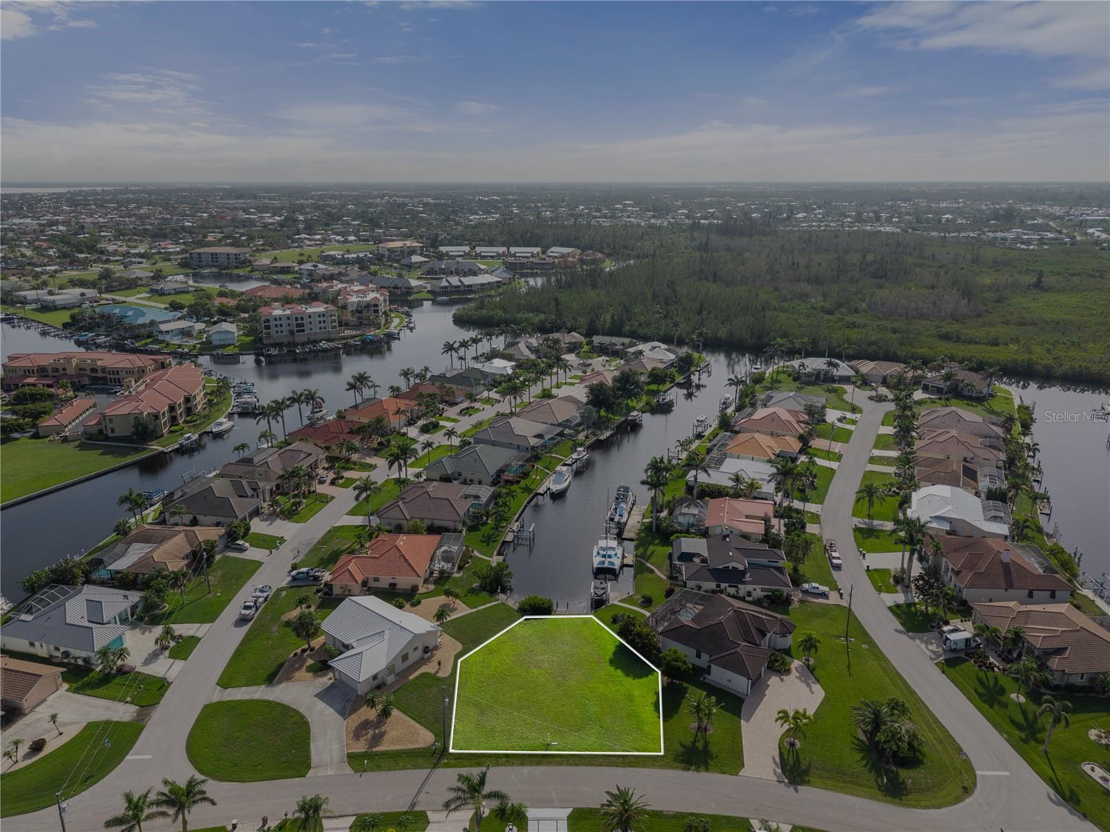 Discover an exceptional opportunity to own an oversized 10,600-square-foot waterfront lot in the sought-after community of Punta Gorda Isles! This prime parcel features a 40-foot seawall and a brand-new dock, offering direct access to a wide, picturesque intracoastal canal—just minutes from open water. Set within a beautiful and vibrant neighborhood, residents enjoy a wealth of amenities including boating, sailing, golfing, fishing, shopping, beaches, pickleball, tennis, and a variety of active social clubs. Golfers will especially appreciate the close proximity to St. Andrews South Golf Club, located just around the corner. Perfectly positioned between Sarasota and Naples, with convenient access to both I-75 and US-41, Punta Gorda is a historic waterfront city unlike any other. This is your chance to build the coastal dream home you’ve always envisioned in one of Florida’s most charming and well-connected communities!