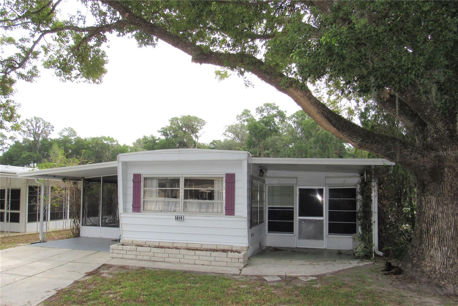 Singlewide with additions. Landscaped Corner lot in a Low-traffic area of the park. 2 Bedrooms, 2 Bathrooms. Street level screened porch + Large vinyl enclosed Florida room with roll down Hurricane shutters. Front Living room with Lamanite flooring. Eat-in kitchen with lots of cabinetry and closet style pantry. Spacious Master bedroom with Large in-suit Bathroom. In-suite features double vanity, a walk-in shower with glass door and an additional closet. Add-on 2nd Bedroom features a private entry from screen porch and an in-suite Bathroom + an entry/bonus area. Exterior features include: 2 covered carports, covered side porch, Laundry/storage space, Vinyl & Aluminum lap siding, Rubber and metal roof, updated AC (2017) Fully Furnished, all major appliances including washer/dryer will convey.