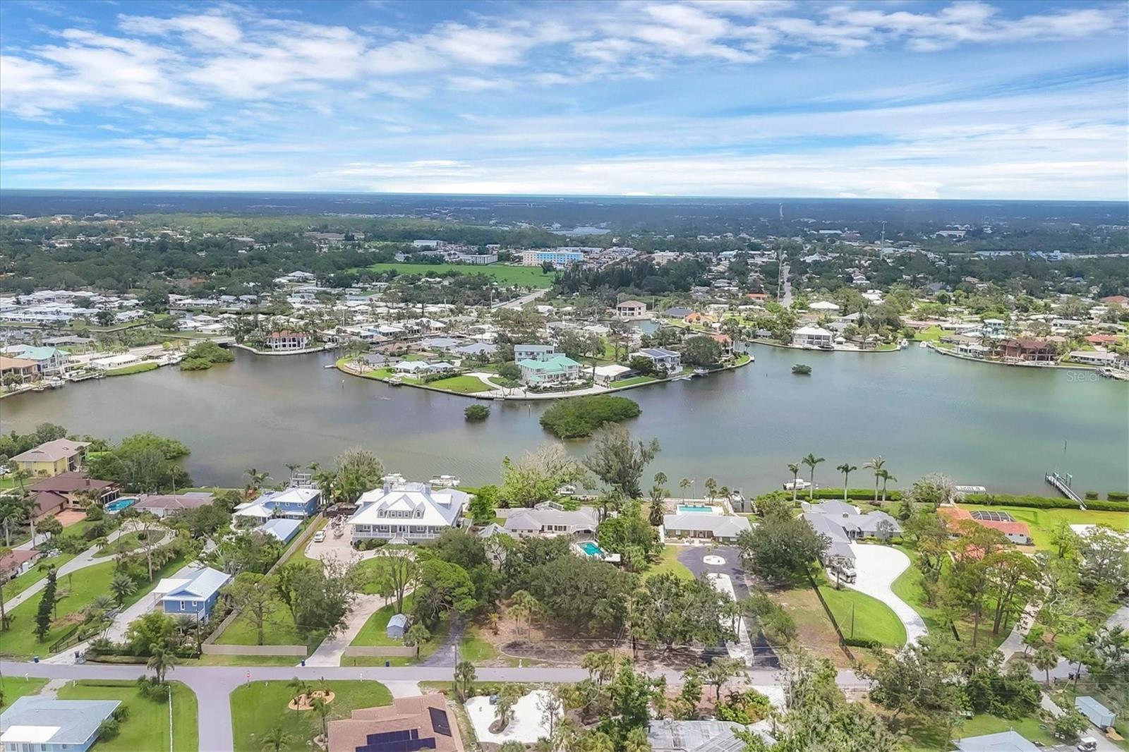 1+ACRES DIRECTLY ON LYONS BAY! Spectacular boating water & view. NO BRIDGES TO GULF OR INTRACOASTAL WATERWAY. All this plus...
Secluded & Private setting on which you can build your DREAM HOME or remodel the existing home. UPDATED KITCHEN with MARBLE counter tops & beautifully finished white cabinetry. WOLF gas range & VIKING refrigerator. 6X7 room with pecky cypress walls off living area, perfect for a bar! Enormous game room with 1/2 bath & French doors leading out to pool. HUGE home with 5 bedrooms & 4+baths. 2 story garage with 1/2 bath. Over-sized room above garage with skylights & separate ac, perfect for STUDIO or bedroom. The POTENTIAL IS ENDLESS. Double primary bedrooms. Charming bay windows add to enjoyment of watching sunrises, dolphins play, or soothe-the-soul water views. So many PRIVATE areas to enjoy the SOLITUDE & view. QUINTESSENTIAL OLD FLORIDA with charm & character. BREATHTAKING SUNRISES. Huge 14x38 pool, pool area is 61x23. Separate hot tub.
EXOTIC LANDSCAPING waiting to be touched up. A gardener's paradise. Large open patio in back, welcoming courtyard in front. Huge side yard with arched block for privacy. Can be accessed thru sliding doors from one primary bedroom. No cage on pool. CONCRETE SEAWALL with dock. SEPARATE BOAT SLIP/BASIN with DAVITS.
PRIVATE & PEACEFUL, yet only MINUTES TO THE GULF, jetty & drum circle, Pop's Sunset Grill or Pelican Alley. Conveniently located between Sarasota & Venice, with easy access to US41 or I75. There is so much to this home, it's impossible to describe. A MUST SEE for any boating enthusiast, water lover, or someone craving a project. OUTSTANDING LOCATION.