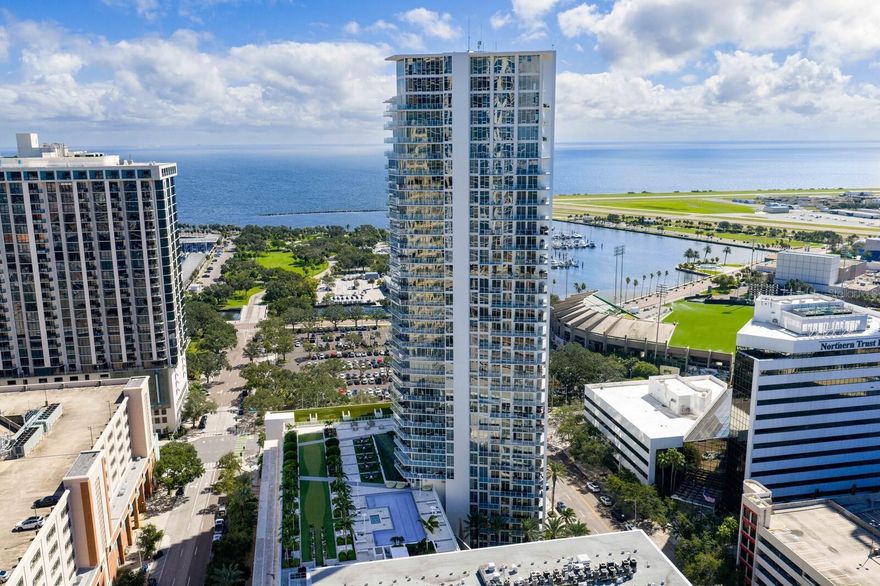 Experience luxury urban living at its finest in this beautifully upgraded 16th-floor residence at Signature Place, one of downtown St. Petersburg’s most iconic contemporary towers. This spacious one-bedroom, one-and-a-half-bath condominium also features a versatile den - ideal for a home gym, home office or potential guest space.

Step inside to discover thoughtfully curated updates throughout, including engineered maple hardwood flooring by BAST Flooring (Hillshire Maple Autumn Collection, 2023), fresh interior paint (2023), and a custom barn door enclosing the laundry area, allowing space for a full-size washer and dryer. The kitchen shines with a new custom tile backsplash, granite countertops, and sleek European-style cabinetry.

Enjoy two private balconies, one off the living room and another off the bedroom, both finished with tile (2020) and showcasing panoramic views of Tampa Bay, the city skyline and Albert Whitted Airport - where you can watch private planes take off and land. Additional highlights include a new water heater (2020), new HVAC system (September 2025), upgraded bathroom with custom decorative wall tile behind the vanity and toilet, Nest thermostat, three ceiling fans, and electric blinds in the living room. This unit also comes with a parking space outfitted with an electrical conduit (2024, $2,200 value) for future EV charging.

Signature Place offers resort-style amenities including a 24-hour concierge, heated infinity-edge pool and spa, fitness center, club and media rooms, brand new outdoor kitchen, and secured parking. Located in the heart of downtown St. Pete, you’ll enjoy walking distance to fine dining, shops, galleries, waterfront parks, the Saturday Morning Market, and year-round events.
