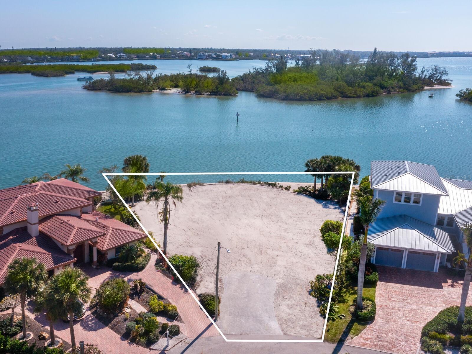 Fronting Roberts Bay, This rare jewel is all about the view and the location. It provides a canvas for a bayfront estate in a neighborhood known for its exclusivity and high real estate values. Old Home has been torn down now. Imagine your very own enchanting residence customized to your exact specifications and unique personalized style. Poised on the prized northern tip of Siesta Key and nestled on the Freeling Drive peninsula, this exquisite parcel represents the perfect blend of sophistication and coastal living in paradise. Bay Island is surrounded by some of Siesta Key’s most admired homes and is an architectural showcase redefining island luxury along one of the area’s most pristine waterways. With an impressive 155 feet of NEW SEAWALL to be built in May, this oversized just under 15,000 square-foot homesite is as exceptional as it gets and offers stunning panoramas of Roberts Bay, looking south to Edwards Islands and the waterways beyond. The location embodies the elevated coastal lifestyle you've always envisioned and is ideal for boating and fishing enthusiasts or enjoying breathtaking sunrises and sunsets in unmatched natural beauty. You'll find yourself just minutes from the vibrant shops and restaurants of Siesta Key Village and the world-renowned Siesta Key Beach, attracting visitors from all over the world. Beautiful downtown Sarasota is just a short drive away, offering galleries, theater, and fine dining. Opportunities like this seldom come along, making this property a true gem for anyone seeking the utmost waterfront address. The ambiance of this treasured location is one where privilege and prestige are imbedded in its affluent lifestyle. Don’t let this one slip by before you’ve had the chance to experience the magic for yourself!
