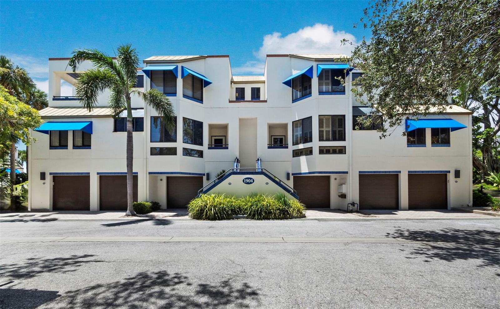 Bathed in natural light, this 2BR, 2.5BA townhome in Fairway Bay at Bay Isles offers an inviting blend of warmth, character, and coastal sophistication. Inside, soaring ceilings and neutral finishes highlight the home’s open design and timeless appeal. The galley kitchen, complete with a charming breakfast nook framed by plantation-shuttered windows, is the perfect place to enjoy morning sunshine. Skylights crown the adjacent dining area, infusing it with light and drama, while the spacious living room - with its fireplace and sliders to the enclosed patio - creates a natural gathering space. From here, a private walk-down provides direct access to Fairway Bay’s resort-style amenities. A guest half-bath adds convenience on the main level. Upstairs, a dramatic catwalk overlooking the dining space and skylights leads to two en-suite bedrooms. Each offers cathedral ceilings, while the primary suite impresses with dual vanities and a spa-like bath featuring a soaking tub beneath an arched skylight. This residence also includes a 2-car garage with a large bonus room—an ideal setting for a workshop, studio, or extra storage. As a resident of Fairway Bay, you will enjoy Deeded Beach Access at the Bay Isles Beach Club, 24-hour gated security, a heated pool, tennis & pickleball courts, fitness center, and all the privileges of Bay Isles living. Optional membership at the Longboat Key Golf & Tennis Country Club and deepwater slips are also available, elevating the lifestyle even further.