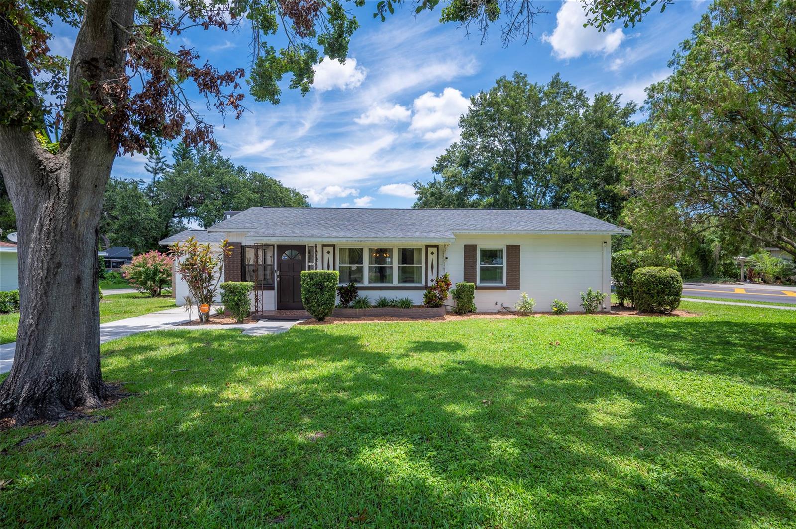 Welcome to this beautifully updated 2-bedroom, 2-bathroom home perfectly situated in the heart of Lakeland—directly across from Common Ground Park, tennis courts, and offering scenic views of the Cleveland Heights Golf Course. This prime location provides easy access to some of the city’s best recreational spots and is just 1/4 mile from Lake Hollingsworth! Inside, you'll find a thoughtfully renovated kitchen (2021) featuring sleek stone countertops, white shaker cabinets, and stainless steel appliances—perfect for both everyday living and entertaining. The primary bedroom offers both comfort and functionality, featuring dual closets that provide generous storage space. With plenty of room for a king-size bed, this room serves as a peaceful retreat at the end of the day. Major upgrades have already been taken care of: a new roof and A/C system were installed in 2021, and updated windows throughout enhance energy efficiency and bring in abundant natural light. The home also includes a flexible bonus room—a 15x10 space fully transformed in 2021 and complete with its own window A/C, ideal as a third bedroom, home office, studio, or guest suite. Outside, you'll enjoy the fully fenced backyard (installed in 2024)—a perfect private retreat for pets, play, or gardening. The patio addition in 2022 creates an inviting space for dining during the cooler months. This move-in ready home blends modern updates with an unbeatable location—don’t miss your chance to own in one of Lakeland’s most desirable areas!