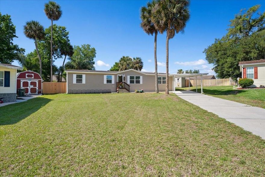 Experience the true essence of Florida living in this meticulously updated home that embodies space, comfort, and convenience. Just minutes away from the ''World's Most Famous Beach,'' this residence is nestled in a well-maintained, friendly community on over a third of an acre, featuring a stylish privacy fence and a custom storage shed that enhance your outdoor enjoyment. Imagine spending countless days and nights in this serene haven, where entertaining friends and family is effortless. The home boasts impressive upgrades, starting with stunning new LPV floors that flow seamlessly throughout. The stylish kitchen features updated 36'' Shaker cabinets, a functional kitchen island, and elegant countertops, making it a culinary enthusiast's dream. Enjoy your cooking experiences with brand-new appliances, including an updated refrigerator, dishwasher, microwave and updated stackable washer and dryer.

With added peace of mind provided by a newer air conditioner and water heater, along with fresh interior paint, this house is all set for you to make it your home.
The unique, flexible floor plan is a rare find, featuring two distinct living spaces - one formal area and another that combines dining and a family room - allowing you to customize your living experience to fit your lifestyle. Ample parking is available with a covered carport and an extended driveway, accommodating all your needs.
There's so much to love about this beautiful home, and words can't fully express its charm. Schedule a visit to see it in person and discover the lifestyle that awaits you!