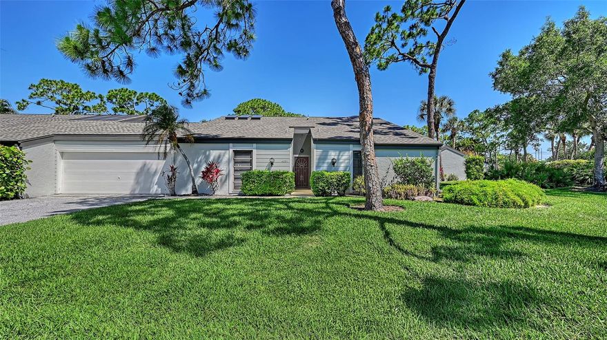 Nestled in the highly sought after community of Woodmans Chart, this 2 bedroom/2 bath villa combines architectural character, abundant natural light, and a resort style lifestyle just 15 minutes from downtown Sarasota. Soaring vaulted ceilings with striking wood beams create warmth and charm throughout most of the home, while recent interior paint and new plank-style tile flooring add a fresh, modern touch.  The spacious living area also has a sun room adjoining it with a large skylight that basks the area in light, and creates a bright and welcoming gathering space.  A spacious primary suite features a row of French doors that open to the main living area, enhancing the home's airy, open feeling.  What was most likely once an open atrium has been thoughtfully enclosed to create a stunning sunroom featuring three skylights set into the vaulted ceiling. Bathed in natural light and surrounded by two walls of French doors, this inviting space would make an exceptional art studio, reading room, or extra sleeping area for guests. The entire rear of the home is designed to bring the outdoors in, with walls of glass featuring dual four-paneled sliding glass doors and a large picture window overlooking the expansive 35-foot screened lanai-perfect for entertaining, relaxing, or enjoying peaceful garden views. Just off the dining room, a door leads to a private outdoor patio finished with charming brick pavers-an ideal setting for relaxing outdoors in complete privacy, enjoying morning coffee, or soaking up the Florida sunshine. From the patio, you have direct access to the spacious two-car garage, offering both convenience and ample storage. Residents of Woodmans Chart enjoy access to two community pools as well as a private tennis court tucked away among mature trees and lush landscaping, adding to the peaceful, resort-style that makes The Meadows such a sought-after community.  The 1600 acres of The Meadows offers 14 miles of scenic trails and optional memberships to a fitness center, tennis and pickleball courts, a Junior Olympic pool, and golf.