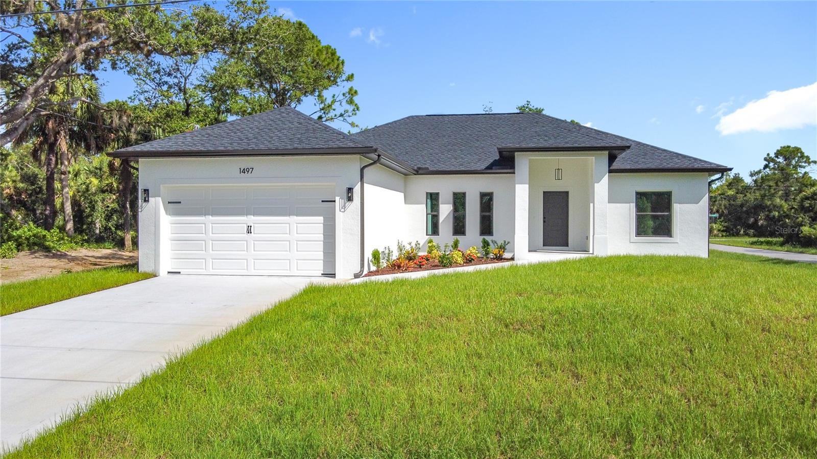 BRAND NEW in Port Charlotte! Enjoy the safety, security, and opulence of a brand new 2025 build with no wait time for construction. See the full 3-D TOUR at NorthPortNewConstruction.com IMPACT WINDOWS AND DOORS. You will LOVE the oversize corner lot location with easy access to all things great in the area. Three spacious bedrooms and two well appointed bathrooms. Upscale ceiling fans and fixtures throughout the home. You will enjoy the XL Primary suit with an ample walk-in closet, a lengthly dual sink basin vanity, walk in shower with floor to ceiling tile, a separate toilet room, linen closet, and an amazing BLUETOOTH ENABLED MIRROR! Rock out to your favorite tunes while soaking in the modern bathtub and relaxing the day away. Your guests will have the benefit of the well-equipped guest bathroom with the tub shower combo and tastful tile over the tub extending to the ceiling. The fantastic kitchen with all wood cabinets and a fantastic and beautiful Quartz pattern countertops will please any cook. Lots of counterspace and an island with even more storage and counter space complements the high quality appliances. No sweat doing laundry in your under air laundry room complete with a handy wash tub style sink. ENJOY the peaceful view from your lanai while sipping your favorite morning or evening beverage. Whether you're looking for a seasonal escape, full- time residence or investment property, this will fulfill your quest. Port Charlotte offers a relaxing coastal lifestyle with just the right mix of charm, convenience, and recreation—perfect for home buyers seeking a vibrant yet peaceful community. The Port Charlotte area affords scenic waterfront living with easy access to boating, fishing, and kayaking on Charlotte Harbor. Nature lovers appreciate the nearby parks, biking trails, and wildlife centers, and families enjoy the laid-back pace and friendly atmosphere. Whether you're into sunset cruises, local seafood, or simply enjoying Florida's sunshine year-round, Port Charlotte delivers a lifestyle that feels like a permanent vacation. Call your agent to arrange a private showing today!