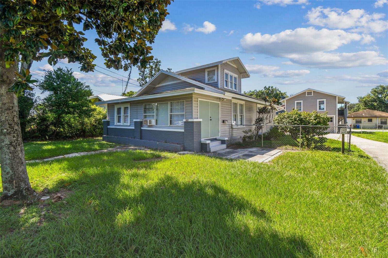 Just a few blocks from picturesque Lake Hollingsworth, this charming property offers the perfect blend of character, comfort, and flexibility. The beautifully updated 1341 SF main home features three bedrooms and two full bathrooms, gleaming hardwood floors, modern central heating and air conditioning, and a convenient stackable washer and dryer in the laundry room. Adding to its appeal is a detached two-story 480SF garage apartment with one bedroom and one bathroom—ideal for guests, rental income, or a private home office. The garage apartment is metered separately and has its own address, 307 1/2. Both the main house and the apartment have been completely rewired for peace of mind, making this a truly move-in-ready opportunity in one of Lakeland’s most desirable neighborhoods.