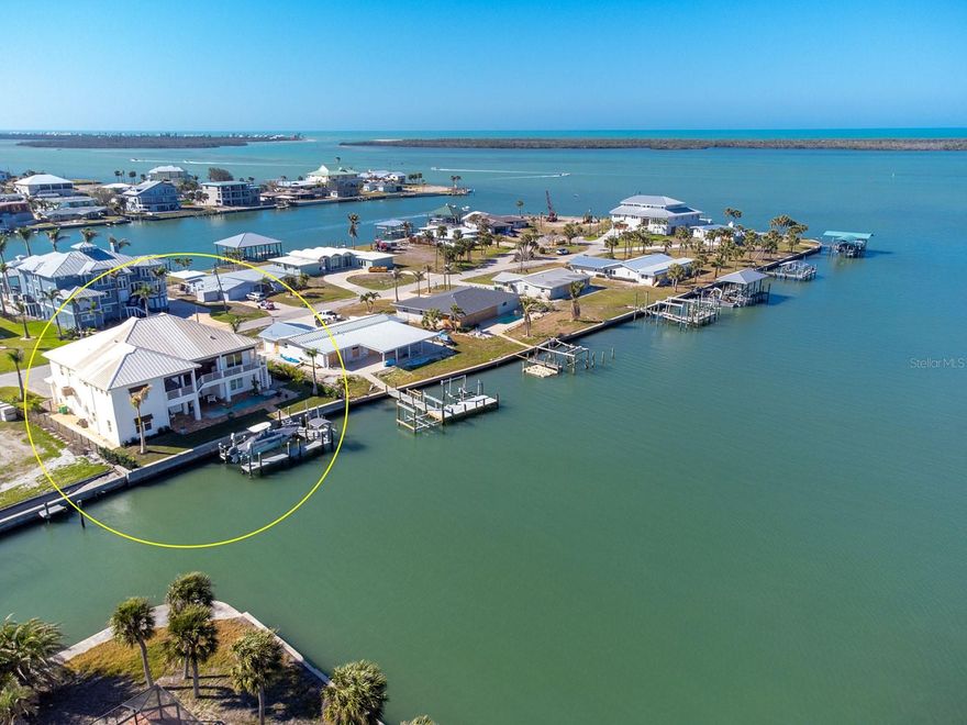 Perched on the Intracoastal waterway, just around the corner from Stump Pass and the Gulf - this masterfully designed, CUSTOM-BUILT WATERFRONT FORTRESS is a rare fusion of West Indies-inspired elegance and cutting-edge modern luxury. Offering UNPARALLELED BAY VIEWS, multilevel outdoor spaces, and every imaginable amenity, this home invites you to fall in love with the beauty of the Southwest Florida—where manatees, dolphins, and vibrant birdlife create an ever-changing natural spectacle right in your backyard. Designed for the ultimate coastal lifestyle, this home transitions effortlessly from refined indoor living to spectacular outdoor indulgence. The RESORT-STYLE POOL AND ELEVATED SPA provide a tranquil retreat, while the expansive deck—complete with an OUTDOOR KITCHEN—sets the stage for sunset soirees over the water. For the boating enthusiast, A PRIVATE DOCK WITH TWO BOAT LIFTS (12,000# + 3,500#), a kayak launch, CUSTOM FISH CLEANING STATION and additional, sailboat deep-water docking on the north side ensures seamless access to Stump Pass and the Gulf in mere minutes, whether you're fishing the backwaters or embarking on an offshore adventure. Inside, the home’s coastal-inspired architecture gives way to bright, open living spaces curated for both comfort and sophistication. The CHEF’S KITCHEN is an entertainer’s dream, boasting an expansive island, large propane range, designer range hood, pot filler, convection oven/microwave combo, and wine fridge – all open to the expansive great room and dining space. The PRIMARY SUITE is a true coastal oasis, where panoramic bay views set the tone for relaxation. Designed with indulgence in mind, it features his-and-hers walk-in closets, a dual vanity and an oversized shower with dual stations—a spa-like retreat rivaling the finest resorts. Three additional bedrooms and two luxurious guest baths ensure a warm welcome for family and friends, while ELEVATOR ACCESS between floors adds a touch of effortless convenience. Downstairs a BONUS ROOM off the pool with FULL POOL BATHROOM offers additional space for guests, gaming or a home gym! The EXPANSIVE AIR-CONDITIONED GARAGE offers ample space for multiple vehicles, storage, and all your outdoor gear. Built with IMPACT-RATED WINDOWS/DOORS, A DURABLE METAL ROOF, roll down hurricane screens and an elevated 2015 concrete seawall; this home is as storm-ready as it is stunning! Additional features include tropical landscaping, irrigation, fencing, NEW HVAC SYSTEM, tankless water heater, wire security system and much more! PROPERTIES OF THIS CALIBER ARE A RARE FIND—a seamless blend of luxury, adventure, and serene coastal beauty. Don’t let this one slip away!