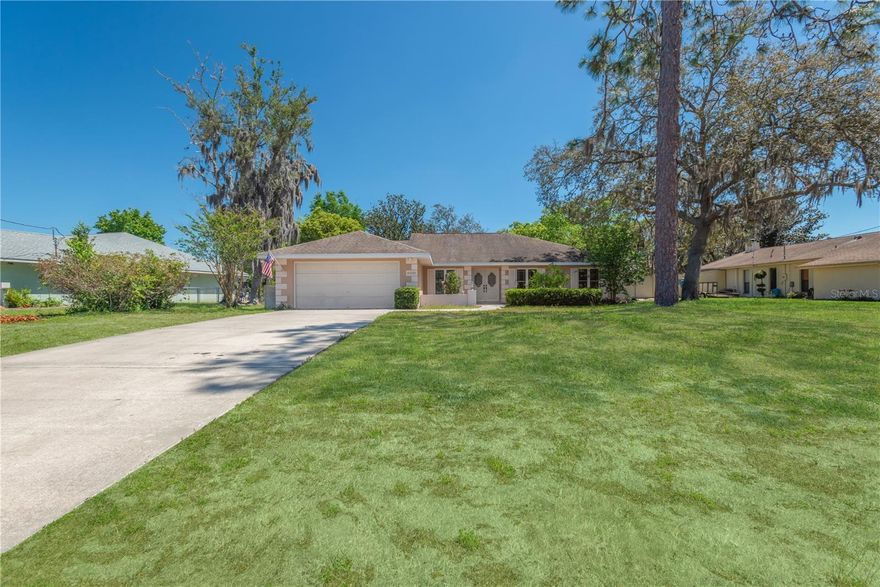 PRICED TO SELL ~~ this home is perfect for the person with a vision to turn a gemstone into a brilliant “Diamond”.  Surrounded by the Oak Hills Golf Course, you will feel the tranquility of a country style atmosphere just minutes from city living.  The lanai, pool enclosure and covered patio area are expansive and ideal for entertaining. The patio can be accessed from the living room, master bedroom and from the 3rd guest bedroom.  As you come through the Front double doors with etched glass, you will be immediately impressed by this open and airy floor plan.  The open floor plan showcases large family gathering room / formal dining room and sitting area/imagination room. The kitchen features a breakfast bar and a separate eat-in kitchen nook overlooking the pool and patio. There is plenty of cabinet space for storing all your cooking/baking items. The laundry room is located directly off of the kitchen and leads out into the oversized 2 car garage. All of the bedrooms are ample in size and feature an abundance of closet/storage space.  The master bedroom features a large walk-in closet with shelving for organization and an ensuite bathroom with His/Hers vanities and exquisite full tile shower with listello accent.  The kitchen, breakfast nook and bathrooms have easy care tile flooring. The master bedroom, living room / dining room highlight a durable wood look laminate flooring. The guest bedroom are carpeted areas and share an updated bathroom with full tile shower and lovely vanity. This home is a blank slate ready to be enhanced by a creative vision.  Affordably priced on 0.36 acre of land complete with pool on the 6th fairway of OAK HILLS golf course is an amazing value.  Don’t delay.  This home is waiting for you!!!