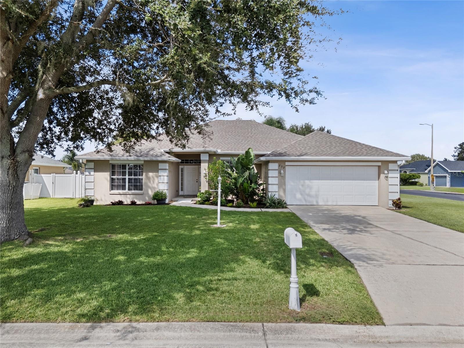 Welcome to 232 Terranova Blvd, a beautifully maintained 4-bedroom, 2-bathroom home with a screen-enclosed and heated pool and spa, ideally positioned on a large corner lot in the highly sought-after gated community of Terranova. Offering a 2025 roof, a 2025 water heater, a newer pool pump and electric pool heater and a 2020 A/C system, this residence combines peace of mind with stylish living. Step inside to discover an inviting open floor plan with vaulted ceilings and solid surface flooring throughout. The spacious great room is the heart of the home—perfect for relaxing evenings or casual gatherings. The formal dining room provides an elegant space for entertaining but could also serve as a home office or additional living room. The well-designed kitchen features granite countertops, gorgeous cabinetry with under-cabinet lighting, tile backsplash, stainless steel appliances, a breakfast bar, closet pantry, and a secondary casual dining space which overlooks the pool. The primary suite offers serene pool views and an en-suite bath complete with a walk-in closet, a granite vanity with dual sinks, a soaking tub, tiled walk-in shower and a private water closet. The split-bedroom design places three additional bedrooms and a full guest bath on the opposite side of the home, providing ample privacy for family or guests. An interior laundry room adds convenience and efficiency to your daily routine. Outdoor living is a true retreat, with a sparkling heated pool and spa, a covered lanai for lounging or dining, and a screened enclosure for year-round enjoyment. The open patio area, beyond the screen enclosure, is the perfect spot for grilling on the weekends! The fenced backyard is ideal for pets, while the 2-car garage provides ample storage with a ceiling drop down storage rack and dual attic entries with decking. Mature landscaping, a large oak tree, fresh mulch, and an irrigation system add to the home’s curb appeal. Additional features include; granite counters and ceiling fans throughout, rain gutters, and more. Located in SE Winter Haven, this home offers quick access to Chain of Lakes Elementary, Publix, Walmart, AdventHealth ER, and numerous dining options—all just minutes away. With Hwy 27 only a short drive away, you’ll also enjoy convenient access to Tampa, Orlando, and Florida’s world-famous attractions. This is a move-in ready pool home in one of Winter Haven’s most desirable gated communities—schedule your private showing today!