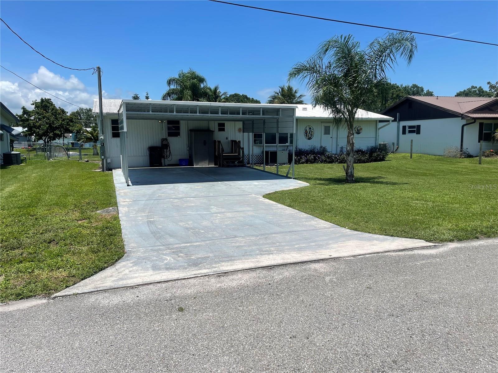 TREASURE ISLAND WATERFRONT WITH LAKE OKEECHOBEE ACCESS!! Perfect for the weekender, winter resident, or full-timer. Spacious single-wide with nicely done additions, Florida room, and a huge screened porch. This property is on a deep canal, close to Taylor Creek, the Taylor Creek locks, and Lake Okeechobee. Good seawall, dock, and boat lift. This property is completely furnished and ready to move in. Back yard is chain-link fenced. Advance for sewer hookup is PAID IN FULL. Bring your toothbrush and start enjoying the Okeechobee waterfront life.