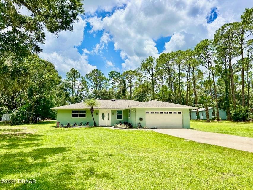 STUNNING HOME WITH 1.38 ACRES!!! Come see this gorgeous, remodeled 3/2/2 split plan home including a detached 650 sq ft utility storage unit/workshop. You will love the beautiful kitchen featuring newer shaker cabinets, soft close drawers/doors, quartz countertops, stainless steel appliances, backsplash tile, pantry and breakfast bar. Master and guest bathrooms have newer, contemporary tile and are tastefully updated. Plantation blinds, shutter, crown molding, distinct pendants and baseboards add finishing touches to this awesome home. House exterior is freshly painted July 2025! New Roof-2018, Water Heater-2022, 3 exterior doors and triple slider-2024. Cantex box for generator. Concrete block/slab home. Huge, fenced yard. Room for a pool. Generous parking for cars, boats, trailers and RVs. No HOA!! Garbage/stormwater are included in the county annual tax bill. Only minutes to beach, restaurants and shopping. Easy access to I-95/I-4. Come check out this Port Orange beauty!