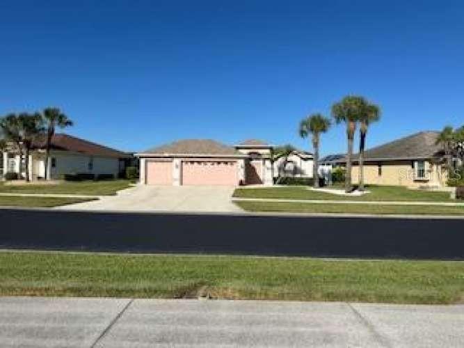 Location! Location! Location! Discover unparalleled privacy in this meticulously maintained 3 bedroom, 3 bath, 3 car garage, courtyard style home in the gated community of Sabal Trace where you have elbow room between neighbors unlike those new construction homes. Enjoy breath taking lake views and the private oasis with a salt water pool. Enjoy Low HOA fees in one of the most sought after neighborhoods in North Port! It's very rare that a courtyard home comes up for sale in this gated community because there are only 4 of this style home in a neighborhood of 104 single family homes. This home offers a Trifecta effect with extraordinary lake views, private pool and huge three car garage! Also has many updates including; exterior painted in 2022, new roof & gutters in 2023, new vinyl fence in 2024, new life proof vinyl flooring in all 3 bedrooms in 2022, remodeled primary bath in 2025, new appliances, new LED fixtures throughout, new work bench with peg board in 2024 and newly remodeled laundry room in 2025. You will not find a better location to watch the sunrise and enjoy the tranquility of nature! This courtyard plan has a separate guest suite with it's own full bathroom and coffee nook. This versatile area can be used for guests, teenagers, or a home office. The possibilities are endless! Please note; the seller has a Florida real estate license and home being sold "As Is". Your private oasis awaits! Very little notice needed to come see for yourself!