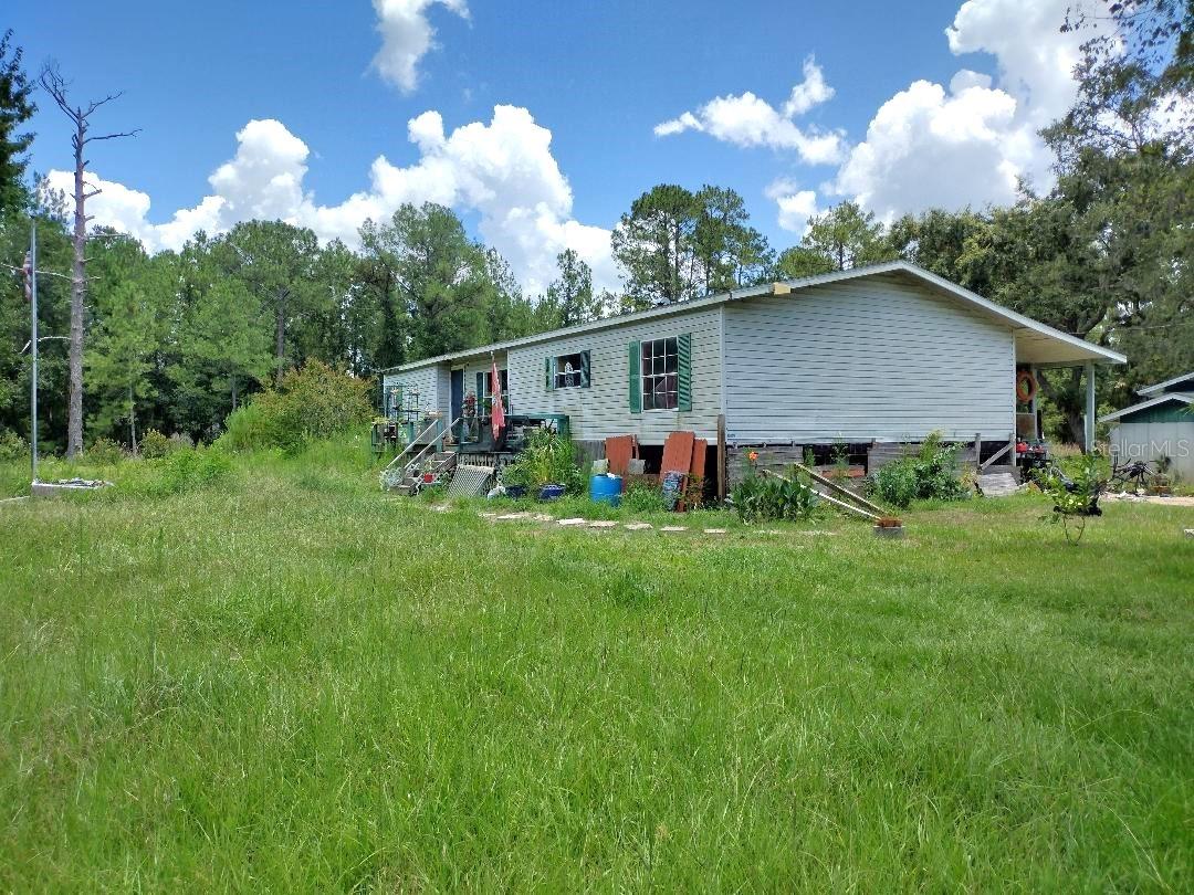 Escape to peace and privacy on this 10-acre country retreat nestled among beautiful hardwood trees with a serene pond and a long, private driveway. Whether you're looking for a homestead or a weekend getaway, this property offers incredible potential and natural charm.
A 1993 double wide manufactured home sits on the property and is ready for your personal touch—handyman special with solid bones and loads of opportunity to renovate and customize to your taste. Enjoy the tranquil setting surrounded by nature, where deer, birds, and wildlife roam freely. Located within minutes to Bull Creek with public boat ramps, and RV sites .
The acreage includes multiple sheds for storage, a chicken coop, and plenty of space for gardening, farm animals, or recreational use. The property is set well off the road, offering ultimate seclusion and privacy, yet still within a reasonable drive to town amenities.
Whether you're looking to build, renovate, or just relax, this peaceful country property offers the freedom and space you’ve been looking for.
Roof original, A/C 2024, Tankless hot water heater,