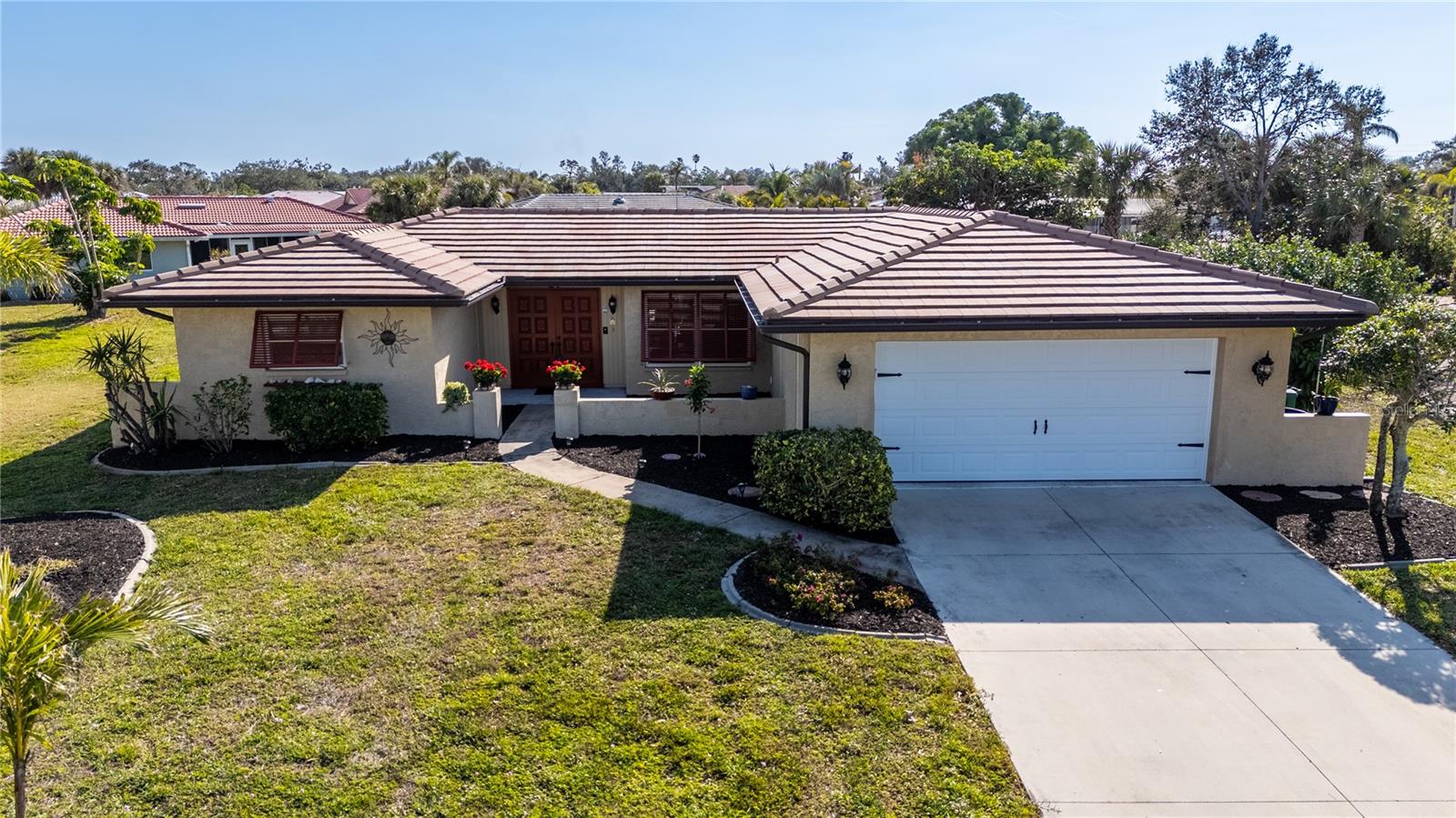 WOW! Check out this price for a 3 bedroom pool home in the popular boating community of Englewood Isles. This home has been meticulously maintained and is being sold TURNKEY FURNISHED, so just unpack your bags and start enjoying the Florida lifestyle. In this great home you'll find BRAND NEW IMPACT WINDOWS AND DOORS THROUGHOUT and the tile roof is only 10 years old. All the appliances are less than 5 years old and you'll enjoy many hours of relaxation or entertaining on the huge lanai and HEATED pool area that has been recently remodeled with new pool surface, all new pavers and a NEW POOL CAGE. The best news yet is this home is SOLAR POWERED and takes care of all your energy needs including heating the pool. The floorplan is so versatile with the ability to have a formal dining room or a front dining room and a back family room. Storage won't be a problem with a big double pantry type closet in the hallway to the garage, plus a smaller pantry in the kitchen. The extra deep 2 car garage is as neat as a pin with an epoxy floor and nice storage cabinets. The 2 guest bedrooms are generous in size and both have ceiling fans and share a nice guest bath with tub/shower combination. The primary bedroom on the opposite side of the house has an ensuite bath with walk in closet. The the EAT IN KITCHEN with new applicances and a pretty shiplap ceiling, you can access the formal dining room or make it a family room. There is a slider out to the pool area from the kitchen and living room. Once outside in the pool area with NEWER FINISH, PAVER AND BRAND NEW CAGE, you'll also find a side patio that would be great for grilling. Englewood Isles is a great waterfront community with a marina on Forked Creek where only Englewood Isles residents can own or rent a dock (if available). There are no bridges to the Intracoastal waterway from the marina and it's a pretty boat ride down Forked Creek. This home is an an X500 flood zone! Put all this together with the great price and turnkey furnished, and you have a winner!