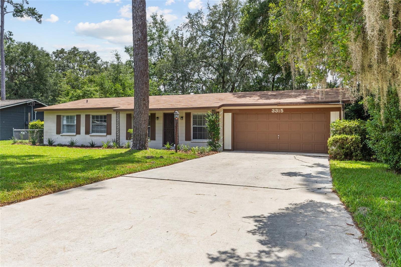 This concrete block, 3 bedroom / 2 bathroom home is conveniently located in the quiet and cozy neighborhood of Northwood. Solid construction, a newer roof (2022) and a newer HVAC (2020), make this property a perfect starter home or a great investment property. When you arrive, you'll appreciate the well manicured yard, ample parking space for family and friends, and vintage ranch-style charm. Step inside to enjoy two large living spaces, a dining room, and a quaint galley kitchen that opens to both living spaces. Fresh interior paint throughout make it light, bright, and create a perfectly clean, blank canvas! Two well appointed guest bedrooms and a spacious guest bathroom offer space for family, guests, or even a home office. The primary bedroom features an en suite bathroom with a standing shower. Outside you'll love the large, fully fenced backyard with mature trees and plenty of privacy from neighbors. Additional features include: a large, enclosed laundry and storage room and an oversized garage. Call for more details or to schedule a showing!