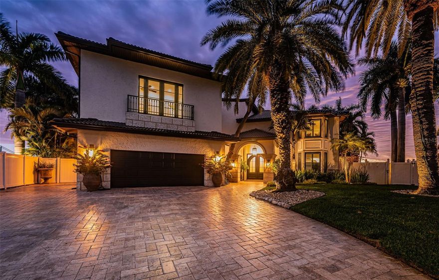 COASTAL CONTEMPORARY LUXURY WITH A UNIQUE TUSCAN APPEAL! Step into a waterfront estate that will raise your senses of sight, sound and touch! Originally built in 1961 but has been rebuilt in 2006. Exquisitely detailed exterior finishes introduce a stately 12ft-high covered entry with splendid arched steel double doors. Inside, discover a spectacular, intricately woven floorplan with dramatic arches, brilliant custom wall finishes, elegant wood flooring, lovely alcoves, superb built-ins and extraordinary woodwork. The expansive great room with its substantial 11ft-high wood ceilings, radiant lighting and cast stone fireplace wall with built-ins, is defined by an amazing wall of 9ft tall sliding glass doors that deliver unforgettable views of the waterfront. The sumptuous open-concept gourmet designer kitchen is a feast of culinary form and function – with aged wood-beamed ceilings, thick Italian marble surfaces, coastal-white raised-panel cabinetry, Wolf/Miele appliances, Bertazzoni gas cooking center, a 3-unit refrigeration wall, full-height wine chiller, huge hammered-copper exhaust, inspired designer lighting, and an incredible island bar with copper farmhouse sink and Italian Marble Waterfall counters (built over a sturdy ancient altar!). You’ll appreciate the fine butler’s pantry and adjacent full-size luxury pool bath. The generous waterfront dining area features two access point to the pool deck. Overlooking the water and opening to a sizable covered deck, the large owner’s suite with dedicated seating area is a welcoming way to begin and end your day. The owner’s bath enjoys beautiful Italian marble surfaces, dual vanities, a dedicated morning bar, an eye-catching all-marble rainshower with digital controls, and a fabulous walk-in closet with built-ins and wonderful center dresser. Upstairs you’ll find an astonishing custom game room with luxurious professional bar; boasting posh wainscoting, rich granite surfaces, custom cabinetry, extensive beverage chilling/refrigeration and surround sound, this will be everyone’s favorite stop to watch the ball game. Step out to the 42ft-wide, 400sqft+ covered balcony and enjoy commanding, panoramic views of the waterfront. Offering an alternative experience, the waterfront fitness room and casual sitting area is a great place to exercise and relax. Two spacious bedrooms share a 20ft-wide waterfront balcony with terrific open water views. A 3rd bedroom is joined to an inviting common sitting area, while the resplendent 4th bedroom provides a Juliette balcony. All bathrooms are lavish in their appointments. Out back you’ll be captivated by a dazzling waterfront setting – a towering 13ft-high 400sqft covered deck with roomy lounging/dining areas and built-in gas cooking center, transitions to a striking Pebbletec pool/spa and your sweeping open water vistas. Impressive travertine paver walkways run the width of the home and are complemented by lush, private subtropical landscaping. You’ll love the dedicated covered waterfront dining area – ideal for large gatherings. The exceptional composite dock features a true rarity, two permanently covered boat lifts with walkway access to both sides of both lifts! Lighting automation, whole house audio, solar electric power and battery backup, and so much more. A magnificent home and tremendous value for all it has to offer. Dimension are estimates, buyer to verify.