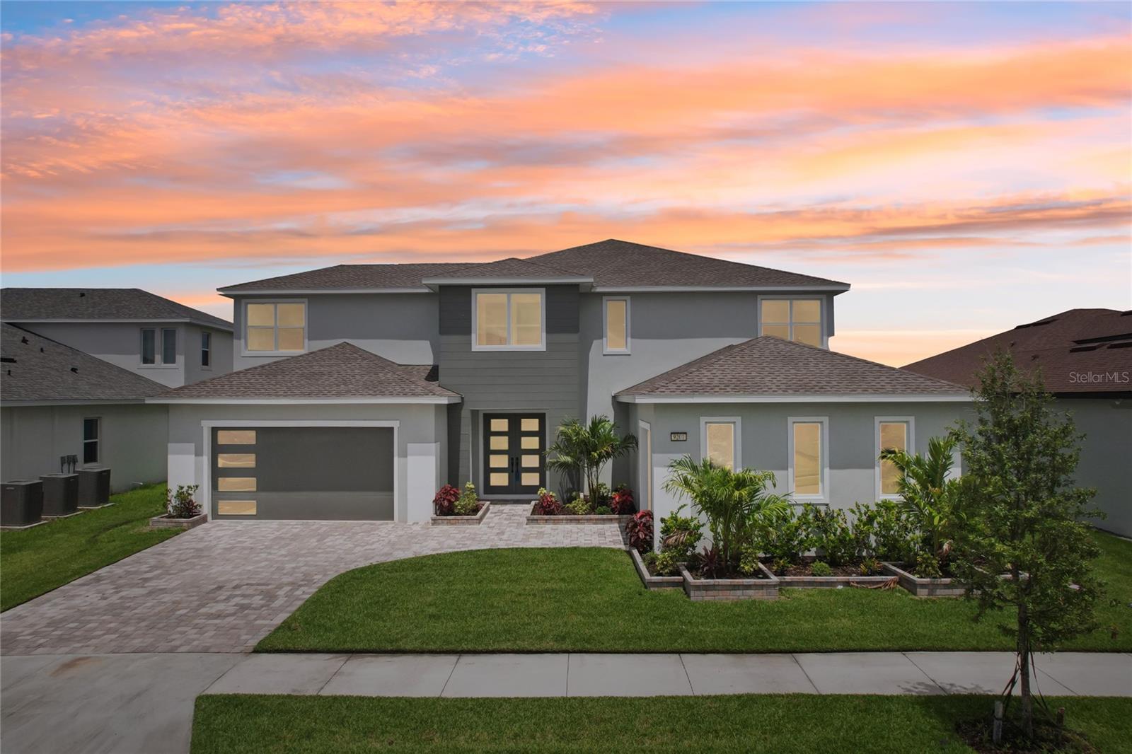 Step into your personal paradise at 9201 Sanders Tree Loop, a showstopping 6-bedroom, 5.5-
bathroom estate boasting nearly 5,000 sq. ft. of beautifully appointed living space. Built in 2023
by renowned developer Biscayne Homes, this contemporary stunner is located in the exclusive
King Lake Estates enclave within the prestigious Epperson Lagoon Community. From the
moment you enter through the grand glass double doors, you're greeted by soaring tray
ceilings, sophisticated crown molding, and designer touches throughout including a vast,
ornamental feature wall that adds texture and intrigue to the space. The expansive open-
concept floor plan allows natural light to flood each area, complemented by upgraded porcelain
tile and luxury vinyl plank. The heart of the home is a chef’s dream kitchen featuring quartz
countertops, a gas cooktop, stainless steel appliances including a double oven, a farmhouse
apron sink, and a spacious butler’s pantry. Whether you’re hosting a formal dinner in the elegant
dining room or enjoying morning coffee in the sunlit casual dining area, every meal here feels
like a celebration. The Owner’s Suite, located on the first floor, offers a serene retreat with tray
ceilings, double doors, custom closet systems, and a spa-like bathroom. Indulge in a sumptuous
soaking tub, dual vanities with plenty of storage and counter space, a walk-in rainfall shower,
and artistic accents that elevate the space to resort standards. A first-floor guest suite offers
added convenience for visiting friends or extended family. Step through massive, floor-to-ceiling,
sliding glass doors to your covered lanai and backyard. In the front of the house, you’ll find lush
landscaping, three garage spaces and a wide paved driveway. Upstairs, the four additional
bedrooms each include their own bathroom, ensuring privacy and comfort. The loft area offers a
flexible space perfect for a game room or media retreat, complete with a wet bar and balcony
overlooking scenic conservation views. Life at Epperson is like being on vacation every day.
Just down the street, enjoy access to a 7.5-acre crystal-clear lagoon complete with sandy
beaches, a swim-up bar, water sports, and year-round events like yoga retreats, movie nights,
and mixology classes. The UltraFi high-speed internet ensures seamless connectivity whether
you’re working from home or streaming your favorite shows. Neighborhood highlights include
Eagle Park, a fitness and event hub that features lush greens and trails, while the Lake House
offers fitness amenities and scenic views. You’ll also find a charming butterfly garden, tot lot
with playground equipment, dog park, and miles of trails for biking, jogging, and golf cart
cruising. Perfectly situated just 10 minutes from KRATE’s unique open-air shopping and dining,
and only 35 minutes from downtown Tampa, this home offers the best of all worlds — peaceful
suburban living with quick access to the city and Florida’s top attractions. Families will
appreciate the proximity to Innovation Preparatory Academy, Watergrass Elementary, and
Kirkland Academy of Innovation High School. 9201 Sanders Tree Loop isn’t just a home; it’s a
lifestyle upgrade. Come see what it means to live where others vacation. Financing available
through P Homme Loans – receive $10,000 towards closing costs!