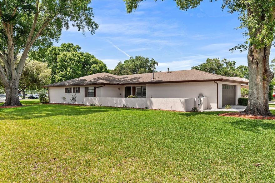 MOVE-IN CONDITION! Charming 2-bedroom, 2-bath patio home on a shaded, landscaped corner lot in Cypresswood Golf & Country Club. This well-maintained single-level residence features a split-bedroom floorplan, expansive great room for living and dining, breakfast nook, carpet and tile floors, skylight, ceiling fans, ample closets including a walk-in in the primary, and a convenient attached 2-car garage with attic access. Enjoy an oversized screened rear porch overlooking picturesque greenspace and mature oaks. Systems and amenities include architectural shingle roof, gas water heater, and full kitchen appliances (dishwasher, range, microwave, refrigerator, washer/dryer). HOA includes community pool and private road; community amenities include an 18-hole golf course, clubhouse with pro shop and lounge, Jr. Olympic pool, tennis/pickleball/recreation area. Convenient to HWY 27, I-4, shopping, restaurants and near Publix.