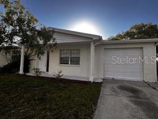 This move in ready 3 bed 1 bathroom bungalow has a 1 car garage, oversized parking pad and fenced backyard! This home is located in the Lakes subdivision of Port Richey is situated just minutes from Little Rd, Embassy Blvd and Highway 19 with easy access to shopping, restaurants, medical centers, beaches and a short commute to Tarpon Springs, Trinity, Clearwater and Downtown Tampa. Has a SPACIOUS and bright interior layout with a large living area that leads to the kitchen and dining area. There are three large bedrooms and one family bathroom in the home. Stunning kitchen with GRANITE countertops, stainless steel appliances, hardwood cabinets and tile backsplash. Beautiful ceramic tile flooring throughout the main house with laminate flooring in the bedrooms. FENCED back yard that is perfect for family, pets and entertaining