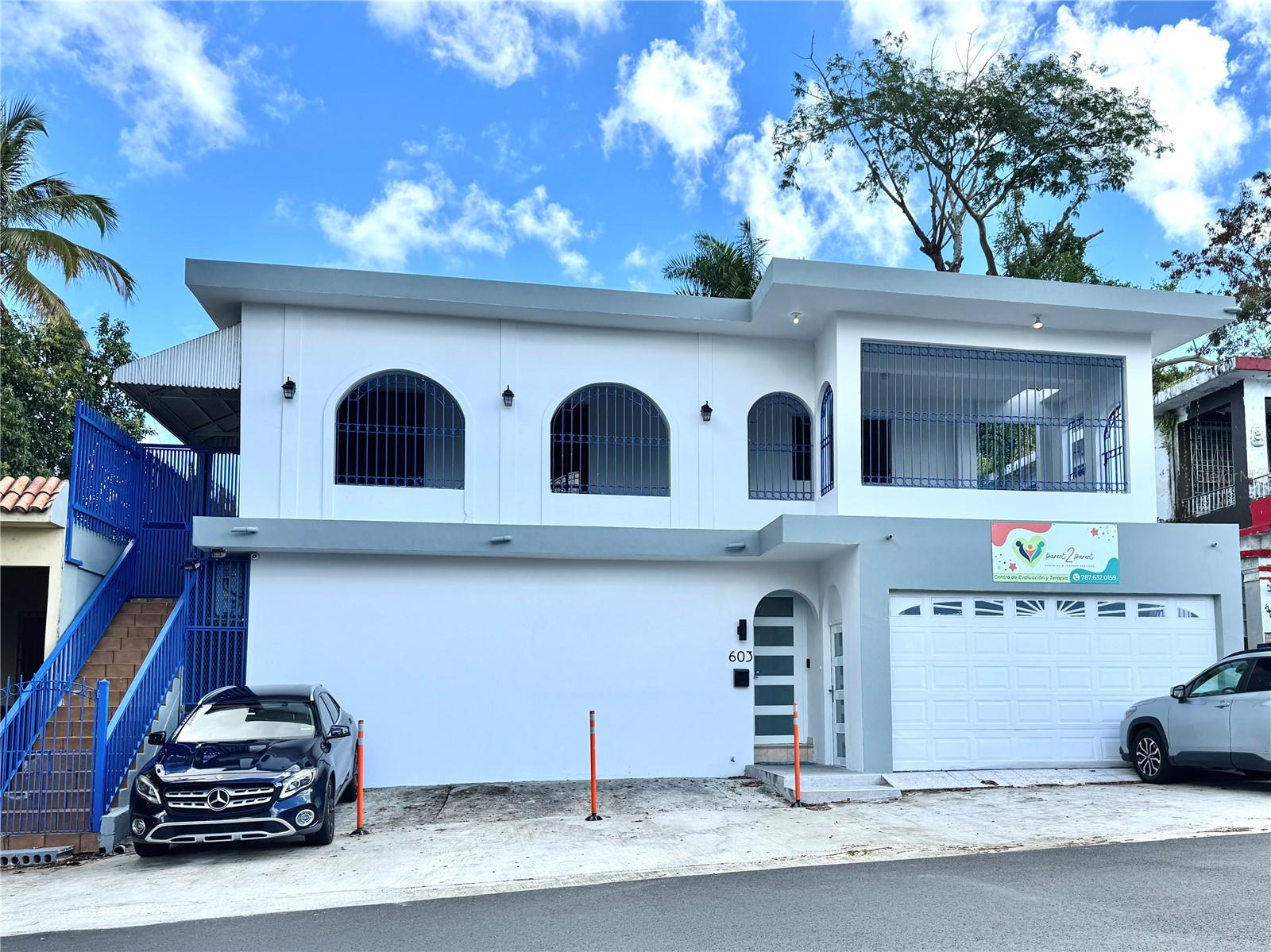 This mixed-use property is a two-story commercial and residential building with a total gross building area of 4,060 square feet and a gross construction area of 5,240 square feet, situated on a 335-square-meter lot in the Caparra Heights development of San Juan, just minutes from San Patricio. Fully leased and generating a monthly rental income of $4,500, the building offers a versatile and well-maintained layout. The first floor spans 2,144 square feet and is divided into two commercial units. One unit, currently leased by a medical office for $2,100 monthly, includes a private entrance, a reception area, three large private offices, a common area or conference room, a full kitchen, a full bathroom, and two dedicated parking spaces. The second commercial space, leased for $900 monthly, features three private offices, a main showroom, a kitchenette, a bathroom, four parking spaces, a large closet, a concrete patio on the back, and a double garage. The second floor is a spacious residential unit rented at $1,500 monthly, offering three bedrooms (two with ensuite full bathrooms), an additional full bathroom, a half bath, living and dining rooms, a family room, a kitchen, and a laundry area. This level also includes a 619-square-foot fenced balcony and an open patio at the rear, providing ample outdoor living space. The entire property is equipped with ten air conditioning units, six of which are new inverter units purchased within the last 14 months. Full roof treatment completed on January 2025.