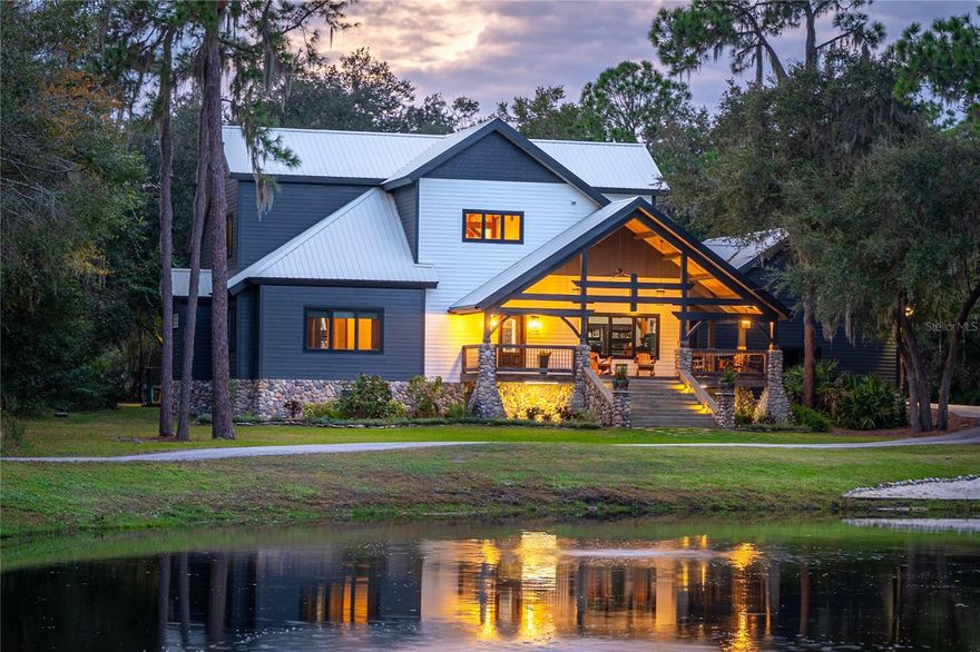 MOTIVATED SELLER, BRING OFFER! Nestled between the vibrant cities of Tampa and Orlando, this South Lakeland masterpiece stands as a testament to luxurious living on 13.9 acres of sprawling beauty. A private entry gate welcomes you to an enchanting world, where an awe-inspiring timber frame home overlooks old Florida woods and a stocked fishing pond, creating a sanctuary of serenity and natural splendor. Crafted meticulously from smooth planed white pine, the residence is a symphony of timeless elegance. Walnut braces throughout exemplify the artistry of the timber frame construction, creating a dwelling that stands as a work of architectural sophistication. Indulge in unparalleled comfort and privacy within the four bedrooms and four bathrooms; three of the bedrooms boast ensuite bathrooms. Each bedroom is a tranquil haven, seamlessly blending with the natural surroundings and providing a retreat-like experience. The gourmet kitchen is a masterpiece with top-of-the-line appliances, wooden cabinets, and quartzite countertops. This space is a culinary dream designed for the most discerning tastes, marrying functionality with exquisite design. Discover a home gym within the bonus room, while the den provides a peaceful retreat with captivating views of the serene fully stocked fishing pond, —an ideal fusion of fitness and relaxation. Indulge in the luxury of hardwood flooring throughout the home, complemented by KOA wood flooring upstairs imported from Brazil which enhances the ambiance of each room, elevating the overall living experience. Ascend the staircase adorned with a custom-designed railing by New Orleans craftsman, infusing the home with a touch of unique character and added sophistication. Step into a backyard paradise featuring a screened enclosure with a heated pool, Jacuzzi hot tub, outdoor kitchen, fire pit, artificial turf putting green, outdoor lighting, and an outdoor shower. This space is an entertainer's dream—a perfect blend of luxury and relaxation. The estate includes a convenient three-car garage and a detached 2,400-square-foot barn, showcasing a 1,200-square-foot apartment above. This fully equipped apartment offers a living space, a full kitchen, two bedrooms, and a bathroom—ideal for guests or extended family. This South Lakeland estate transcends conventional living, offering a lifestyle of sophistication, tranquility, and natural beauty. Arrange your private tour today to immerse yourself in the unparalleled luxury of this home and make it your exclusive retreat in the heart of Florida.***upgrades*** Pool and equipment(2021), Pool cage(2022), kitchen remodel with top of the line-Monogram, café, and Samsung appliances, filtered water system, instant hot water system, two garbage disposals, Under cabinet lighting, solid wood cabinets with soft close drawers, Quartzite counters, large farm sink, and an island sink, five countertops fold down USB and electrical plugs, Elderwood kitchen island, sink base and shelving (2021), Master bathroom remodel with copper tub, overhead multi-function rain shower with LED lights and Bluetooth speaker, Six body jets, two shower heads, and handheld, Flooring- wood and natural stone, Real stone sink, Fireplace over copper tub, Spacious walk-in master closet, Separate toilet room (2021), downstairs real wood flooring(2022), AC#1(2023), AC#2(2018), commercial grade metal roof(2002), Tankless gas hot water heater(2022), Exterior paint(2023), Interior paint(2021)