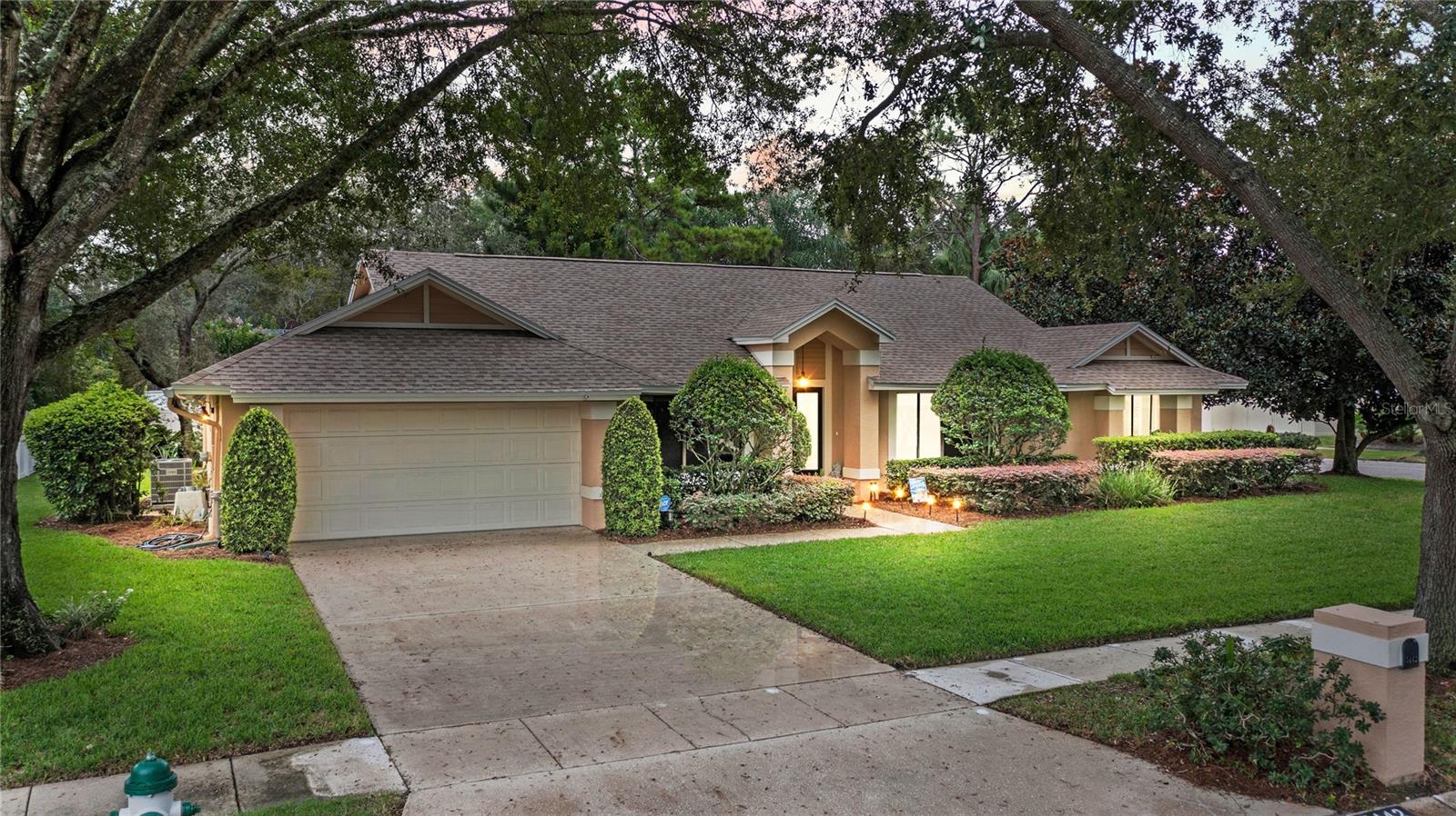 CHARMING, MOVE IN READY HOME in Dr Phillips’ Hidden Estates with an optional HOA! This home features 3 bedrooms, 2 bathrooms, an open floor plan, formal living and dining rooms, a large family room, vaulted ceilings with tube skylights, 2 car garage, inside laundry room, a 500 sq ft covered and enclosed Florida room on a large, corner lot! You will love the neutral paint and ceramic tile, laminate and engineered wood floors and the open floor plan! The sunken formal living and dining rooms will be on either side of the foyer when you walk in the home with the sunken family room in front of you that features vaulted ceilings and a wood burning fireplace. French doors lead to the enclosed Florida room with a brick paver patio just outside of it. The large yard has plenty of room for a pool! What a great space to enjoy your morning coffee, read a book, or unwind after a long day! The kitchen is off the family room and features new stainless steel appliances, a convection oven, Bosch dishwasher, a separate desk area with plenty of counter space, plenty of cabinets for storage with under cabinet lighting in addition to a breakfast nook. The owner’s suite is off the kitchen and features French doors leading to the Florida room, an en-suite bathroom that has been remodeled with 2 separate vanities, a soaking tub, a tiled shower and water closet and a large walk-in closet. The nice sized guest bedrooms are on the other side of the house for privacy and share the guest bath that features a one-sink vanity, a tub/shower combo and a window that lets in natural light. The laundry room leads to the 2-car garage that has a service door to the side yard. The home has been beautifully maintained! Additional updates include a new AC – inside and outside (2024), septic drainfield replaced (2023), new roof (2022), water heater replaced (2018), exterior has been re-painted, new carpet in the Florida room, new ceiling fans, house has been re-plumbed and new toilets installed. Centrally located with easy access to I4, theme parks, great schools - in walking distance, great shopping and minutes from wonderful dining on restaurant row. Don’t let this one pass you by!