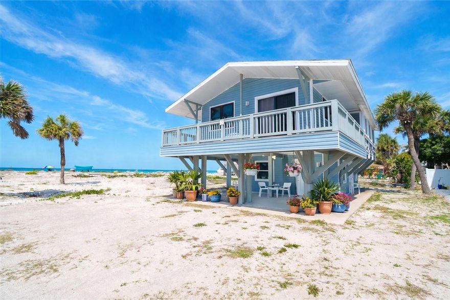 There's something about the beach, the rhythm of the waves, the salt in the air, the way time seems to slow down the moment you arrive. Tucked just one lot in from the Gulf, this elevated 2-bedroom, 1.5-bath beach cottage offers a rare chance to step into that lifestyle. Mornings start with coffee and a short walk to the shoreline. Afternoons drift by with sun, sand, and sea breeze. Evenings end with unforgettable sunsets that never quite look the same twice. Loved and held in the same family for generations, this home carries the kind of warmth and history you can feel the moment you walk in. And through it all, it has stood strong, weathering recent storms with resilience, featuring hurricane shutters throughout and impact-resistant, turtle glass windows on the lower level for added peace of mind. Whether you're looking to reset, recharge, or create a place where memories are made year after year, this is where it happens. Use it as your personal escape, or take advantage of the strong rental potential when you're not enjoying it yourself. This property offers more than just the view, what truly sets this property apart is a chance to breathe a little deeper, slow down, and live the beach life the way it was meant to be.