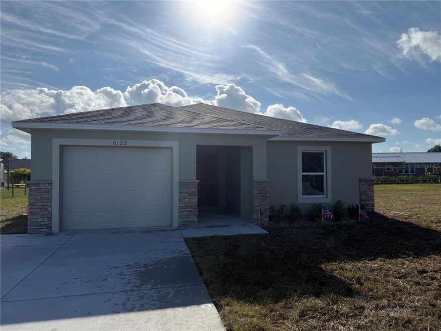 Discover this lovely home with 3 bedrooms and a 2-car garage, situated in West Gate River Ranch, Country Side. The house offers both tile and carpeted floors, a spacious lanai at the rear, and a custom stone finish on the front exterior.