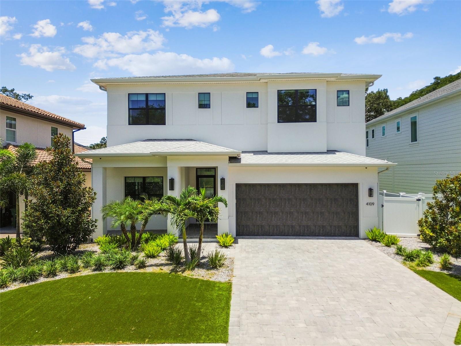 Welcome to the “Sag Harbor” — an exceptional Coastal Contemporary home by Taralon Homes, nestled in one of South Tampa’s most sought-after neighborhoods. Designed for both style and functionality, this 5-bedroom, 5.5-bathroom residence offers curated finishes, flexible living spaces, and a private backyard retreat. A welcoming foyer sets the tone for the open-concept layout that unfolds across the main level. The spacious great room flows seamlessly into the chef’s kitchen, outfitted with Wolf and JennAir appliances, granite countertops, solid wood cabinetry, an eat-in breakfast bar, and a dedicated dining area. A built-in wet bar/coffee station adds ease to morning routines or entertaining. One of the five bedrooms is located downstairs with its own en suite bath and is currently used as a home office—ideal for guests or working from home. A full pool bath and a generously sized mudroom provide smart functionality without sacrificing design. Step outside to your private outdoor oasis: a saltwater pool and spa surrounded by travertine pavers, artificial turf, two fire pits, and a custom gazebo. Mature landscaping offers a sense of privacy, while a removable child safety fence ensures peace of mind. Whether you're hosting a gathering or unwinding in the evening, this space is designed to enjoy year-round. Upstairs, the owner’s suite is a true sanctuary. The stunning primary bath features two separate vanity stalls, a luxurious soaking tub, and a walk-in shower with pass-through design—all anchored by a large walk-in closet. Three additional en-suite bedrooms and a spacious laundry room complete the second floor. Every detail of this home reflects thoughtful craftsmanship, including 7.5" Naturally Aged Medallion Collection “Playa” oak flooring, 7" crown molding, Level 5 drywall, solid core doors, Low-E impact glass windows, and two tankless water heaters. Additional enhancements include a full-perimeter security system, whole-home speaker system, and strategically placed WiFi hotspots—laying the foundation for seamless smart home integration. The 2-car garage provides ample storage, completing a home that blends luxury, practicality, and privacy in one of Tampa’s most desirable locations - just minutes from Hyde Park, Downtown Tampa, TIA, shopping, dining, and major sports venues.