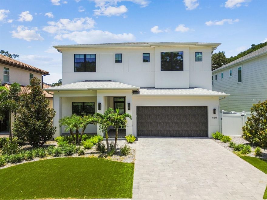 Welcome to the “Sag Harbor” — an exceptional Coastal Contemporary home by Taralon Homes, nestled in one of South Tampa’s most sought-after neighborhoods. Designed for both style and functionality, this 5-bedroom, 5.5-bathroom residence offers curated finishes, flexible living spaces, and a private backyard retreat. A welcoming foyer sets the tone for the open-concept layout that unfolds across the main level. The spacious great room flows seamlessly into the chef’s kitchen, outfitted with Wolf and JennAir appliances, granite countertops, solid wood cabinetry, an eat-in breakfast bar, and a dedicated dining area. A built-in wet bar/coffee station adds ease to morning routines or entertaining. One of the five bedrooms is located downstairs with its own en suite bath and is currently used as a home office—ideal for guests or working from home. A full pool bath and a generously sized mudroom provide smart functionality without sacrificing design. Step outside to your private outdoor oasis: a saltwater pool and spa surrounded by travertine pavers, artificial turf, two fire pits, and a custom gazebo. Mature landscaping offers a sense of privacy, while a removable child safety fence ensures peace of mind. Whether you're hosting a gathering or unwinding in the evening, this space is designed to enjoy year-round. Upstairs, the owner’s suite is a true sanctuary. The stunning primary bath features two separate vanity stalls, a luxurious soaking tub, and a walk-in shower with pass-through design—all anchored by a large walk-in closet. Three additional en-suite bedrooms and a spacious laundry room complete the second floor. Every detail of this home reflects thoughtful craftsmanship, including 7.5" Naturally Aged Medallion Collection “Playa” oak flooring, 7" crown molding, Level 5 drywall, solid core doors, Low-E impact glass windows, and two tankless water heaters. Additional enhancements include a full-perimeter security system, whole-home speaker system, and strategically placed WiFi hotspots—laying the foundation for seamless smart home integration. The 2-car garage provides ample storage, completing a home that blends luxury, practicality, and privacy in one of Tampa’s most desirable locations -  just minutes from Hyde Park, Downtown Tampa, TIA, shopping, dining, and major sports venues.
