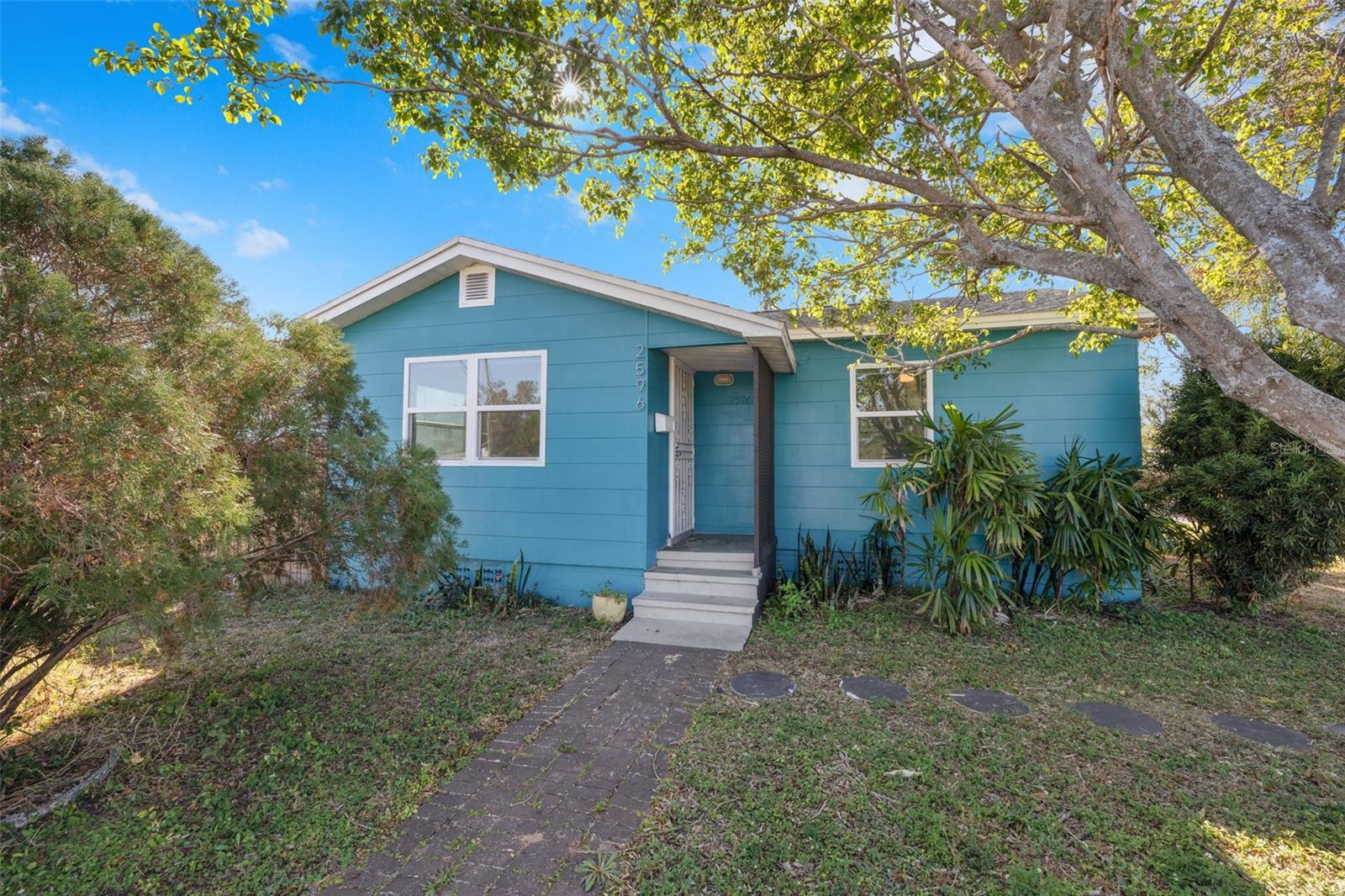 One or more photo(s) has been virtually staged. Nestled in the desirable St. Pete Heights neighborhood, this beautifully updated corner lot home offers modern comfort and timeless charm. Boasting a NEW ROOF in 2025, this beauty provides 2 spacious bedrooms, 1 full bath, and 804 square feet of thoughtfully designed living space. A perfect opportunity for first-time homeowners, or investors seeking a move-in-ready gem. Step inside to a freshly painted interior that sets a bright and welcoming tone. The newly remodeled kitchen is a standout feature, showcasing granite countertops, sleek wood cabinets and updated lighting. Additional upgrades include new lighting fixtures and ceiling fans throughout, new vinyl flooring, new reinforced foundation and a freshly painted interior. The large laundry room adds convenience, while the private fenced backyard provides the ideal space for outdoor relaxation or entertaining. With alley access and ample room for a private pool or detached ADU, the possibilities for customization are endless. Situated in a NO HOA and NO flood zone area, this home offers peace of mind and freedom from extra fees or restrictions. Whether you envision expanding your outdoor oasis or enjoying the current low-maintenance setup, this corner lot is ready to meet your needs for years to come.