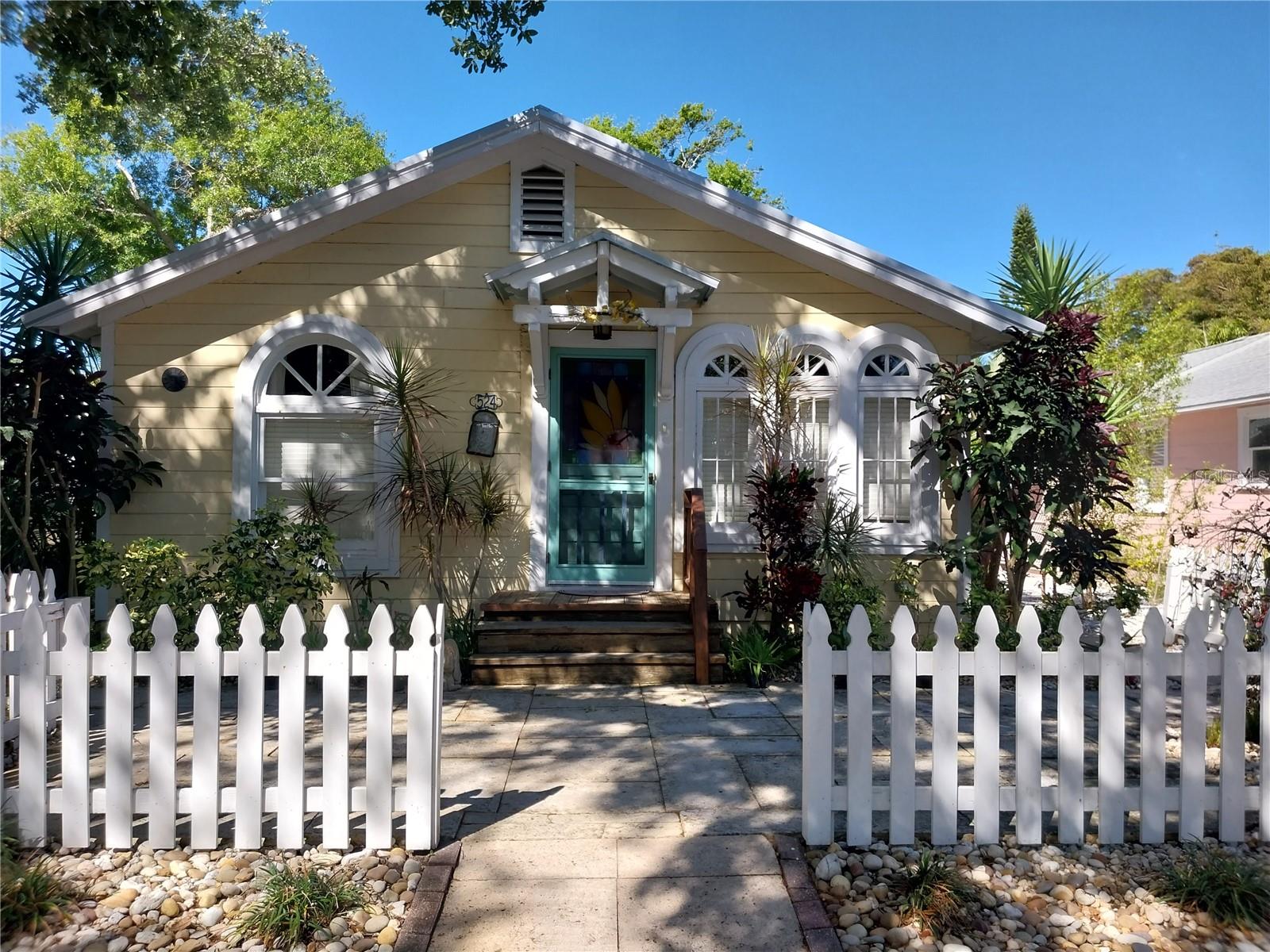 This enchanting 3 bedroom, 2 bathroom bungalow is just what your soul needs! Located in the historic district of Laurel Park, a perfect spot to call home with the convenience of Downtown Sarasota being less than a mile away with a plethora of shopping and restaurants, and just minutes from all of the arts community offerings such as the Van Wezel, theatres, the Rosemary District and more! Another perk is being just 6.6 miles from the world-renowned Siesta Key Beach which features it's own array of shopping, restaurants, and other pleasures of the Village. This home has been beautifully updated but has also maintained it's original charm and is known as "The Sunflower Cottage" with it's stunning yellow color to reflect it's nickname! Providing lots of natural light through gorgeous stained glass and arch windows and adorned with lovely artwork and pieces throughout the home. The home also features a kitchen fit for a chef with butcher block counters, an oversized farm sink and chic white appliances! The guest bedrooms are equipped with a queen size bed in one and twin beds in the other. The master bedroom has a queen size bed and a huge walk-in closet, also an updated en-suite bathroom with a walk-in shower for your convenience. The master bedroom opens up to a screened in, covered back porch where the washer & dryer are located. For your comfort, a lounge sofa set and table for quiet evenings or your morning cup of coffee. The backyard is so neatly maintained with lush and mature landscaping and a magical setting for those quiet moments or times of reflection. For you to enjoy is a tree swing, lounge chairs and foot rests, and a firepit surrounded by chairs and tables. Owner will consider one dog at their discretion. Call now for more details!