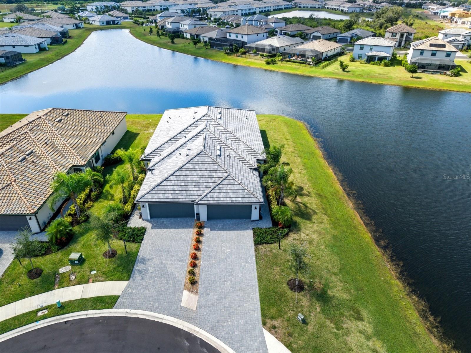 NO FLOOD ZONE! Ask about a 1% lender incentive with our preferred lender!
Enjoy BEAUTIFUL WATER VIEWS FROM EVERY WINDOW in this stunning twin villa, ideally located on a peaceful CUL-DE-SAC in the highly sought-after LORRAINE LAKES community. Designed for both comfort and style, this 2-bedroom, 2-bath home with a DEN/BONUS ROOM showcases an exceptional blend of open-concept living, modern finishes, and serene lakefront scenery.
Step through the welcoming foyer—complete with a stylish SHIPLAP ACCENT WALL—into the bright and spacious GREAT ROOM, where high ceilings and natural light set the stage for effortless Florida living. The open layout flows seamlessly through the DINING AND LIVING AREAS, also highlighted by a shiplap feature wall, and out to a SCREENED LANAI overlooking the tranquil lake.
The CHEF-INSPIRED KITCHEN features granite countertops, a breakfast bar, stainless steel appliances, a pantry, and an under-mount sink. A charming TRANSOM WINDOW ABOVE THE CABINETS adds both warmth and light to the space.
A VERSITLE DEN, enclosed with glass French doors, offers the perfect flex space—ideal for a home office, media room, or POTENTIAL 3RD BEDROOM. The PRIMARY SUITE is a private retreat, complete with French doors, direct lanai access, serene lake views, a large walk-in closet, and an ensuite bath featuring dual vanities and a spacious walk-in shower.
The 2nd bedroom is perfectly positioned near the main bath, which includes a full tub for added comfort. Additional highlights include a DEDICATED LAUNDRY ROOM, TWO-CAR GARAGE with rough-in for drop-down attic access, ON DEMAND HOT WATER HEATER, and HURRICANE SHUTTERS for peace of mind.
At Lorraine Lakes, you’ll enjoy RESORT-STYLE LIVING every day with access to exceptional amenities: three sparkling pools, a splash park, playground, clubhouse with restaurant, tennis and pickleball courts, basketball, a state-of-the-art fitness center, and an active social calendar. The HOA FEE COVERS LANDSCAPING, CABLE, AND SECURITY, making maintenance a breeze.
With its ideal location, BREATHTAKING LAKE VIEWS, and unmatched community amenities, this villa perfectly captures the Florida lifestyle—easy, elegant, and endlessly inviting.