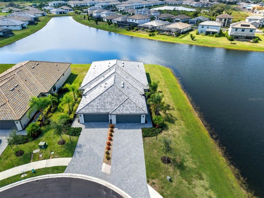 NO FLOOD ZONE! Ask about a 1% lender incentive with our preferred lender!

Enjoy BEAUTIFUL WATER VIEWS FROM EVERY WINDOW in this stunning twin villa, ideally located on a peaceful CUL-DE-SAC in the highly sought-after LORRAINE LAKES community. Designed for both comfort and style, this 2-bedroom, 2-bath home with a DEN/BONUS ROOM showcases an exceptional blend of open-concept living, modern finishes, and serene lakefront scenery.

Step through the welcoming foyer—complete with a stylish SHIPLAP ACCENT WALL—into the bright and spacious GREAT ROOM, where high ceilings and natural light set the stage for effortless Florida living. The open layout flows seamlessly through the DINING AND LIVING AREAS, also highlighted by a shiplap feature wall, and out to a SCREENED LANAI overlooking the tranquil lake.

The CHEF-INSPIRED KITCHEN features granite countertops, a breakfast bar, stainless steel appliances, a pantry, and an under-mount sink. A charming TRANSOM WINDOW ABOVE THE CABINETS adds both warmth and light to the space.

A VERSITLE DEN, enclosed with glass French doors, offers the perfect flex space—ideal for a home office, media room, or POTENTIAL 3RD BEDROOM. The PRIMARY SUITE is a private retreat, complete with French doors, direct lanai access, serene lake views, a large walk-in closet, and an ensuite bath featuring dual vanities and a spacious walk-in shower.

The 2nd bedroom is perfectly positioned near the main bath, which includes a full tub for added comfort. Additional highlights include a DEDICATED LAUNDRY ROOM, TWO-CAR GARAGE with rough-in for drop-down attic access, ON DEMAND HOT WATER HEATER, and HURRICANE SHUTTERS for peace of mind.

At Lorraine Lakes, you’ll enjoy RESORT-STYLE LIVING every day with access to exceptional amenities: three sparkling pools, a splash park, playground, clubhouse with restaurant, tennis and pickleball courts, basketball, a state-of-the-art fitness center, and an active social calendar. The HOA FEE COVERS LANDSCAPING, CABLE, AND SECURITY, making maintenance a breeze.

With its ideal location, BREATHTAKING LAKE VIEWS, and unmatched community amenities, this villa perfectly captures the Florida lifestyle—easy, elegant, and endlessly inviting.
